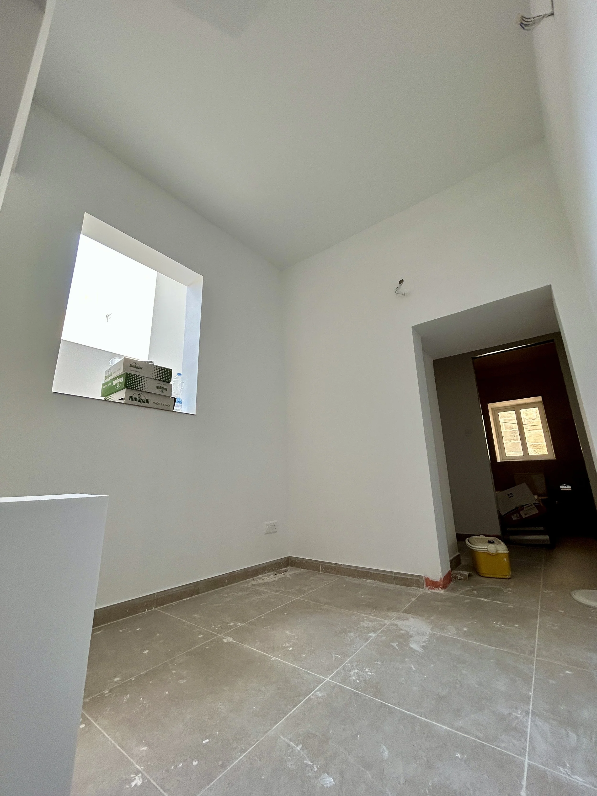 Freshly painted room in Malta with a bright white wall finish.