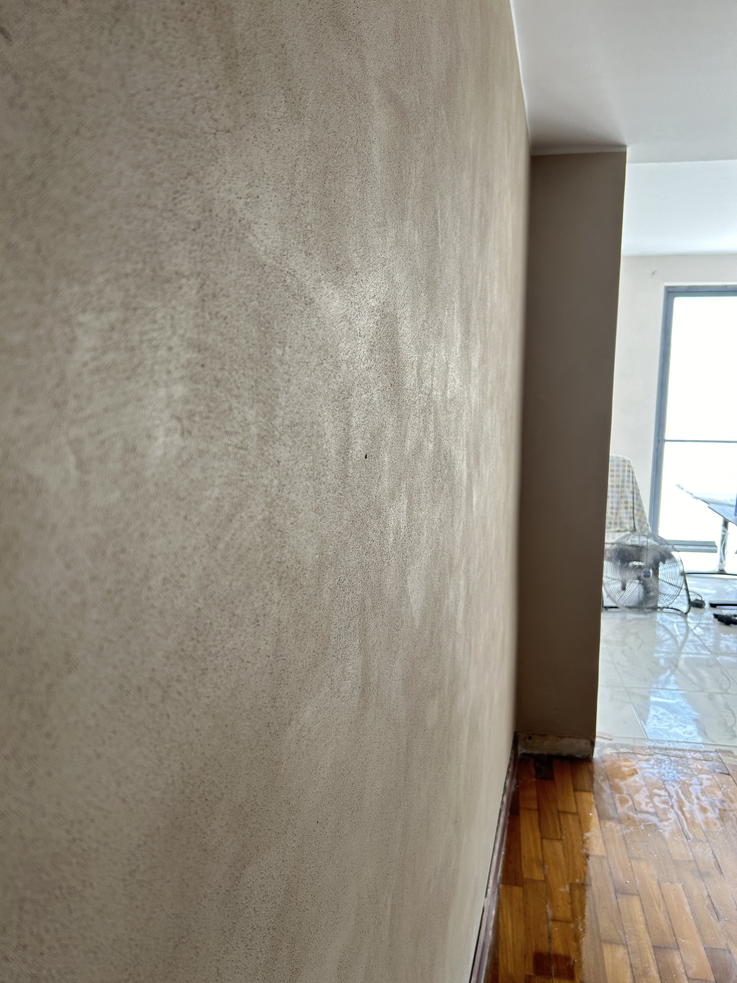 Close-up view of beige textured decorative paint finish.
