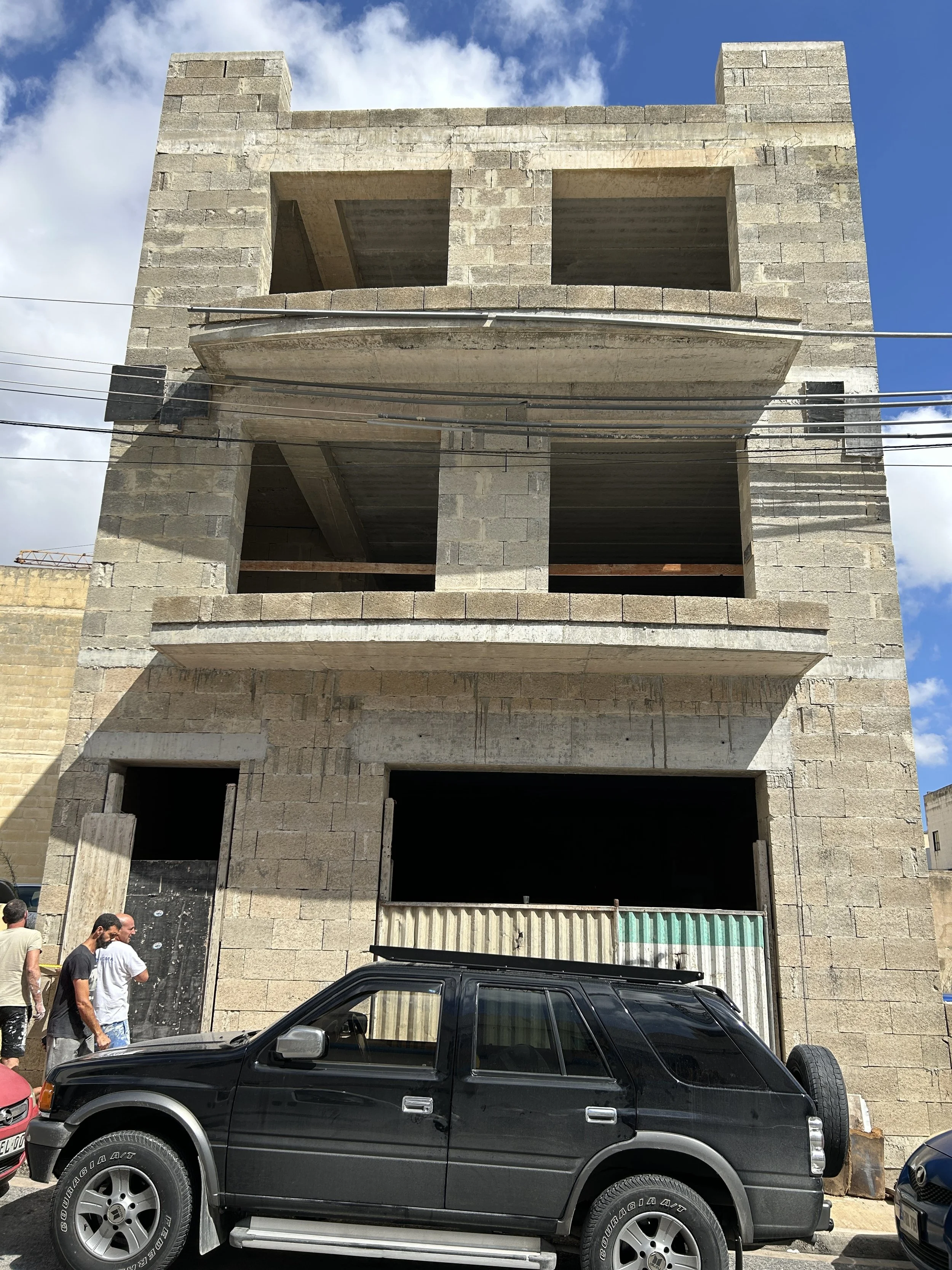 Before photo of facade prior to plastering and painting.