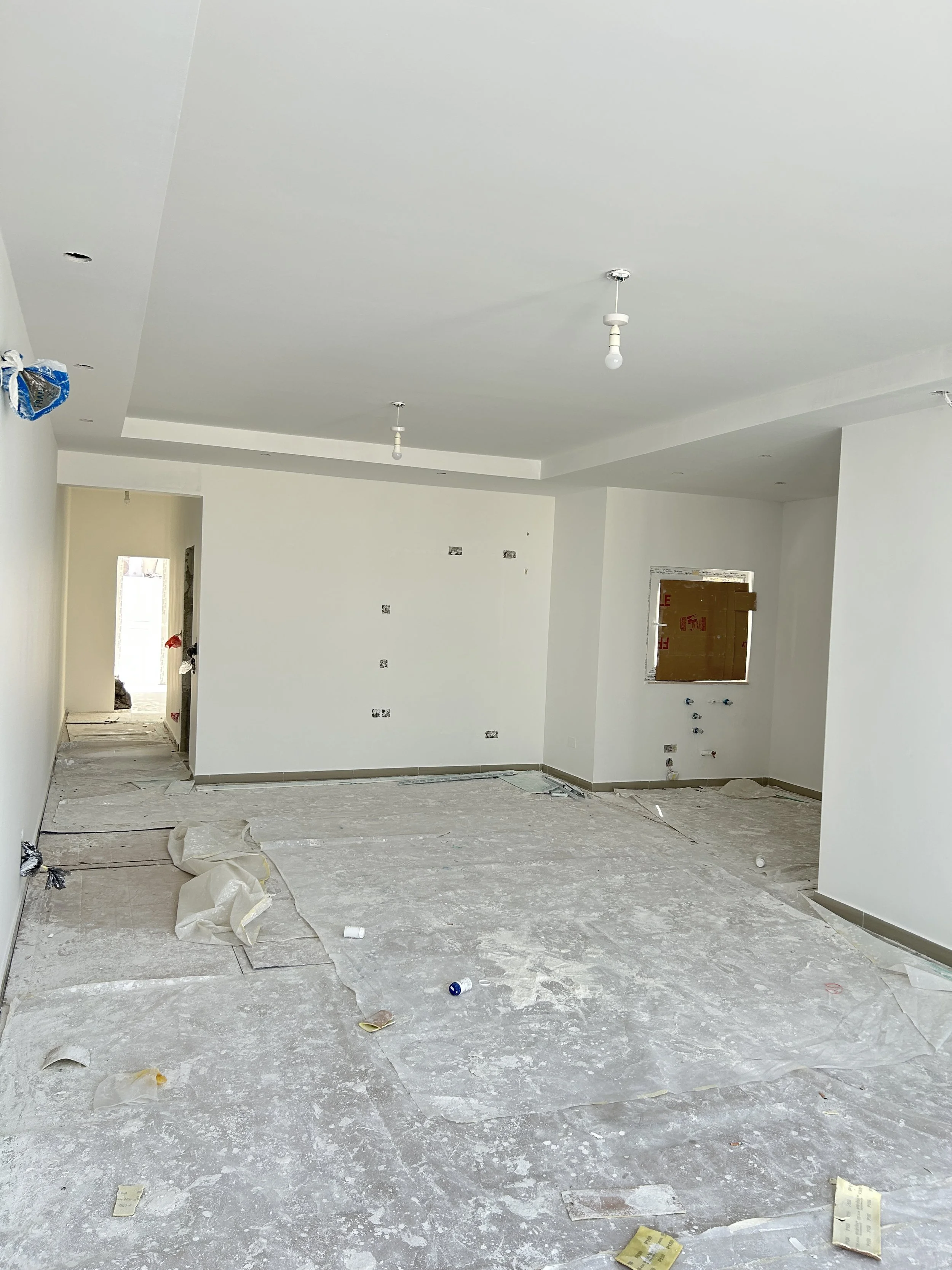 Freshly painted open-plan interior with walls, ceilings, and gypsum bulkhead.