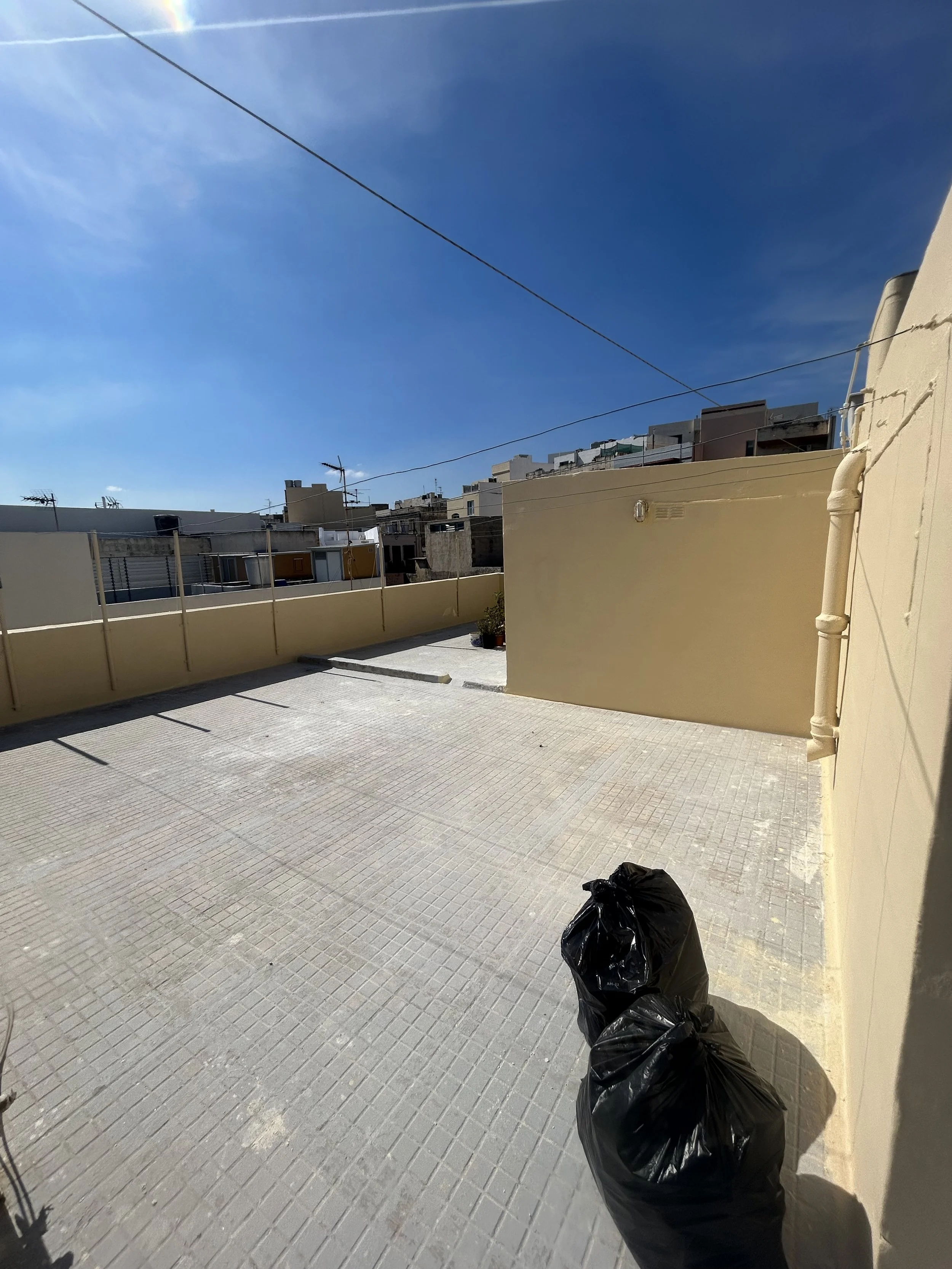 Exterior walls of a Maltese home treated with waterproofing to stop water damage.