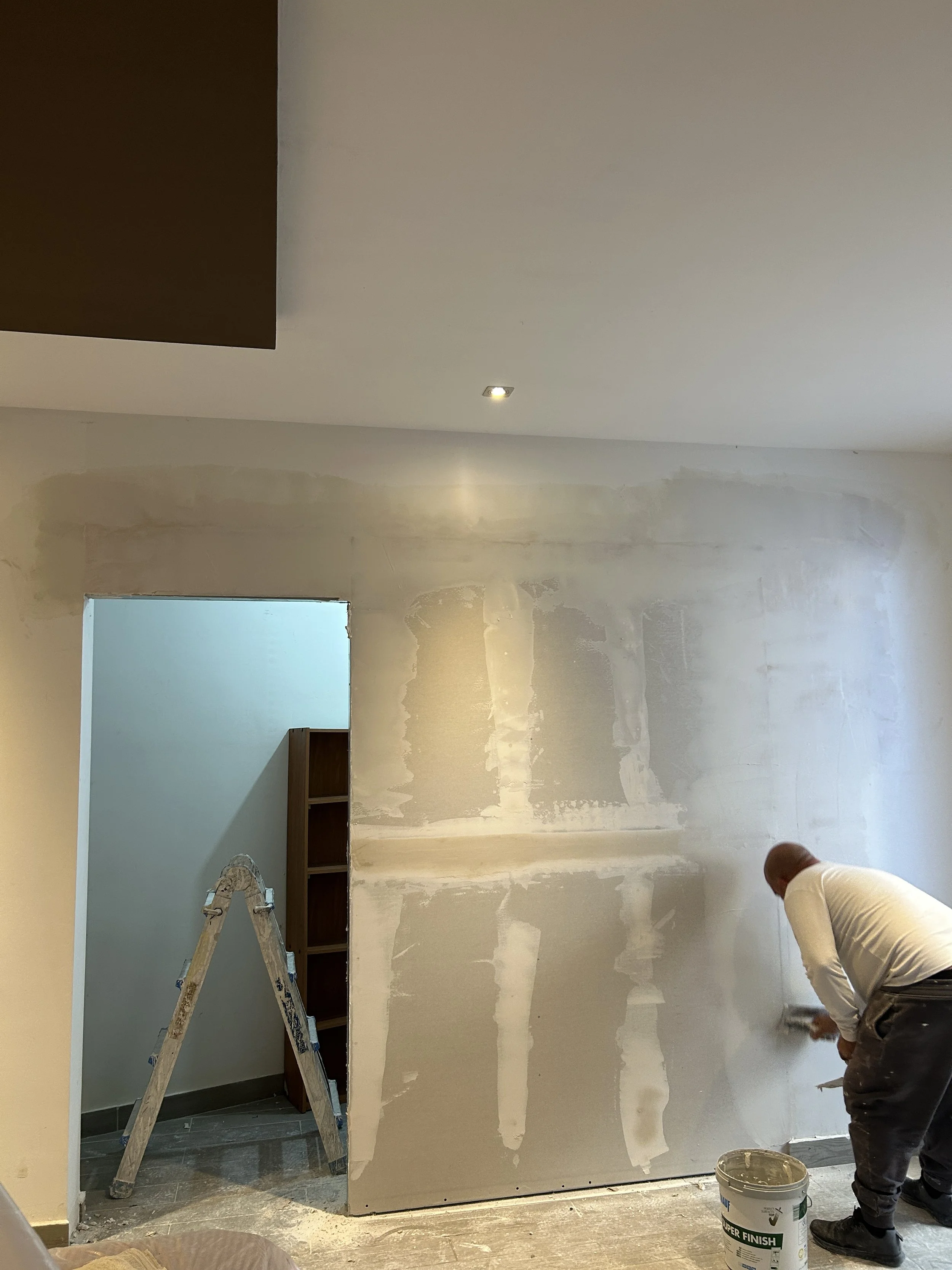 Gypsum partition wall constructed to form a new closet.
