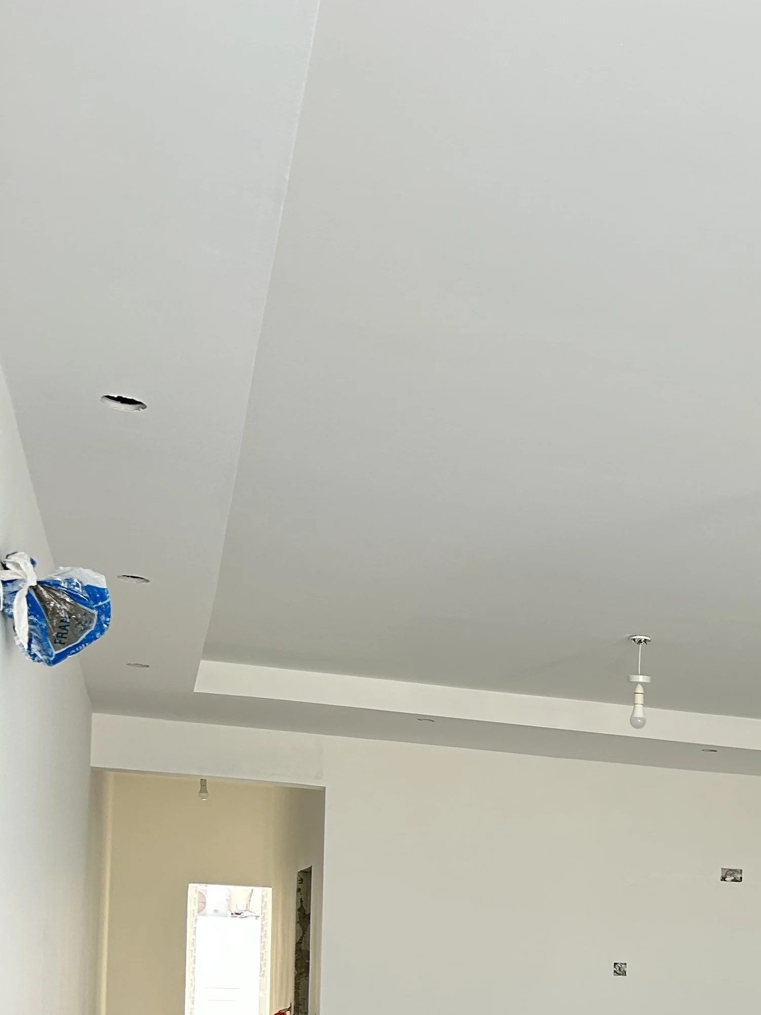 Gypsum bulkhead designed to conceal AC piping.
