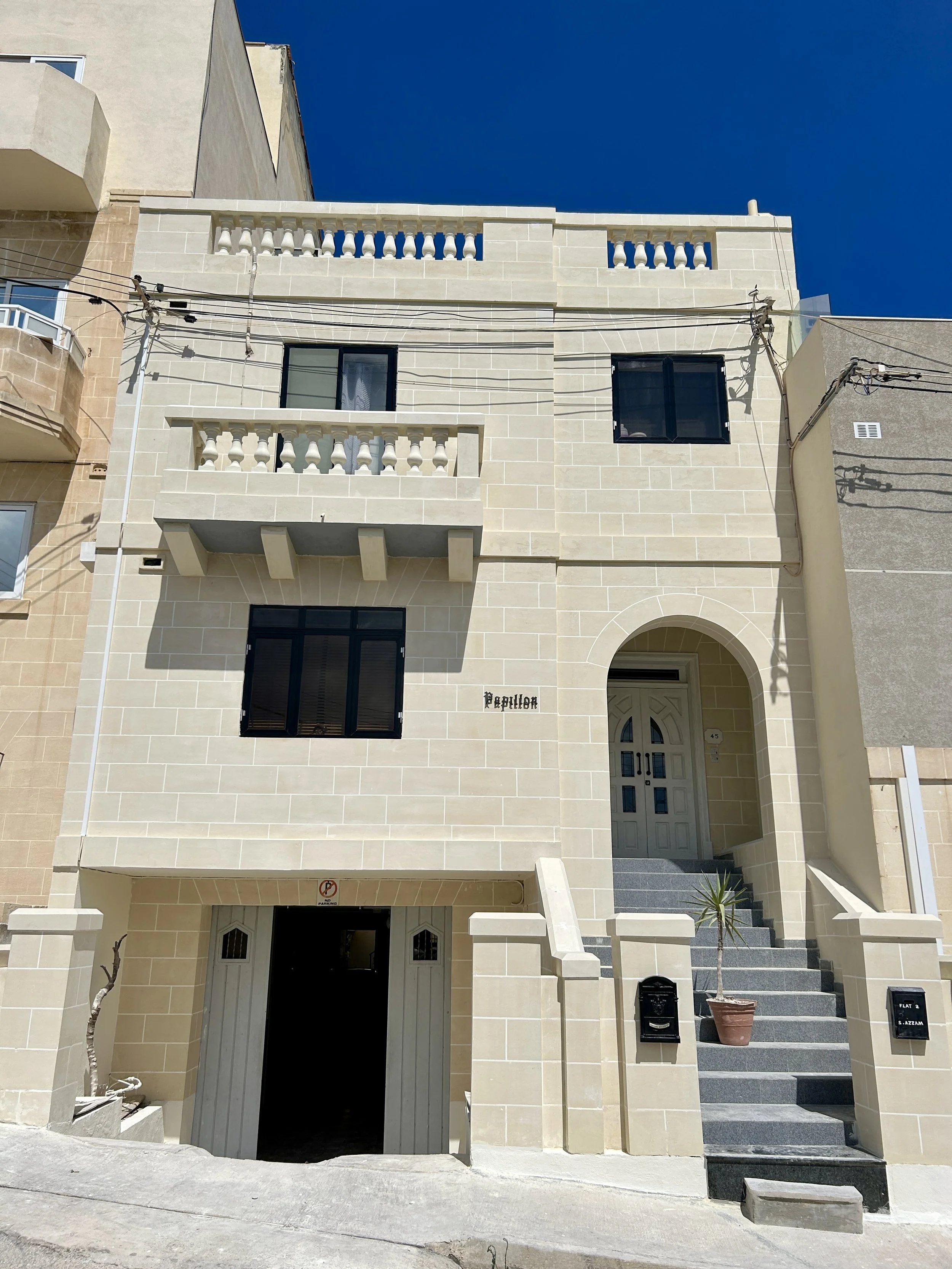 Traditional Maltese fuq il-fil plastering finish applied on a restored facade