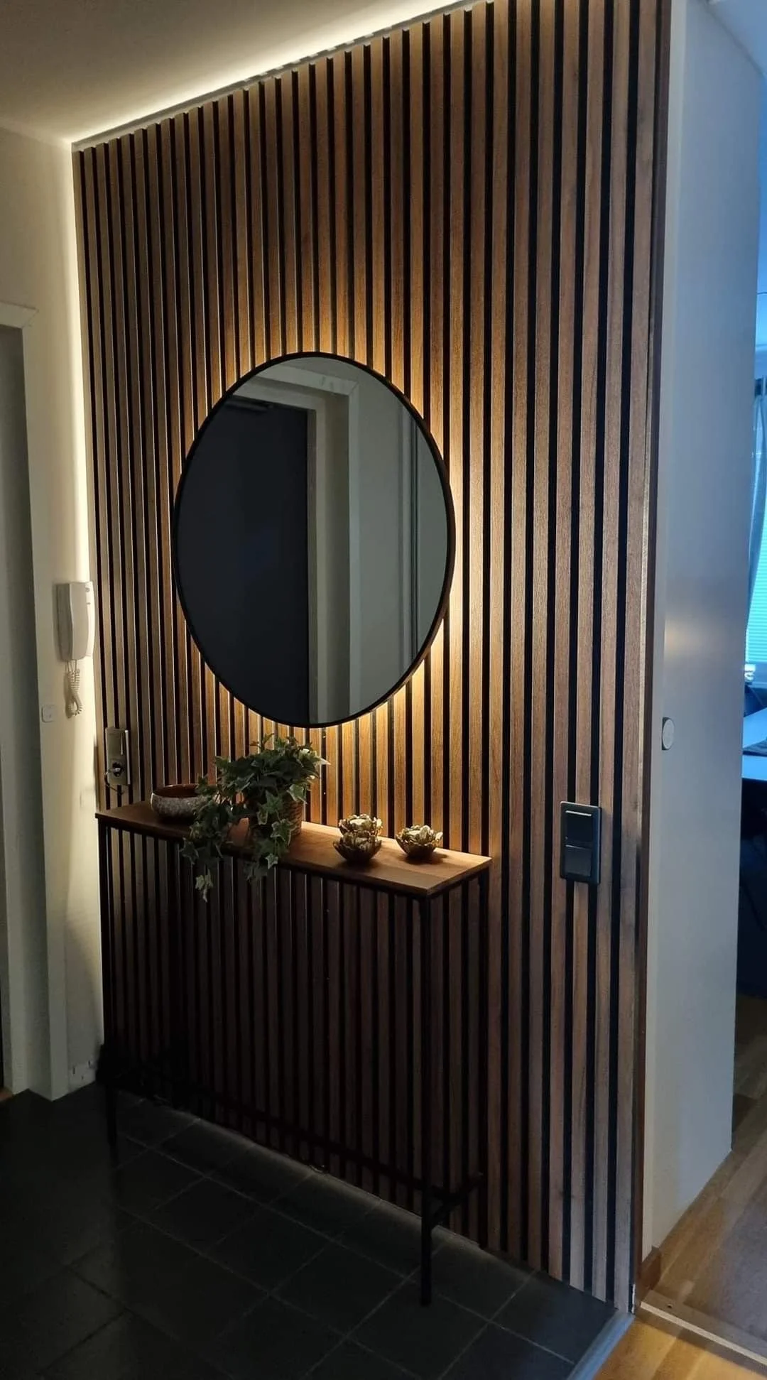 Wooden slat wall feature at a home entrance creating a strong and welcoming first impression in Malta