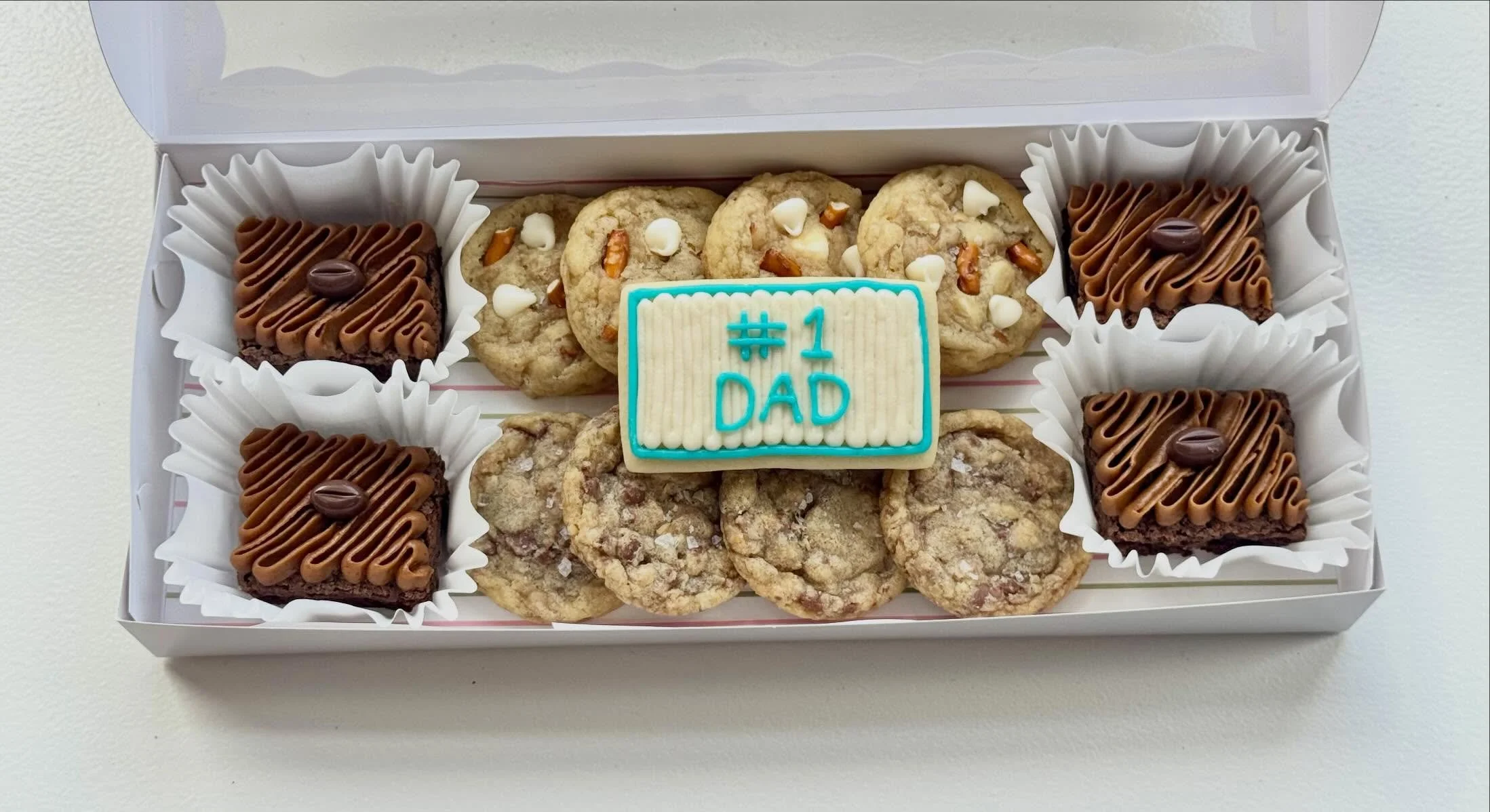 Father&rsquo;s Day Treat Boxes are here! ☕🍪

A carefully curated assortment of bakery favorites for Dad:
&bull; 4 Espresso Brownie Bites
&bull; 4 Pretzel White Chocolate Cookies
&bull; 4 Salted Toffee Crunch Cookies
&bull; 1 Hand-Decorated Buttercre