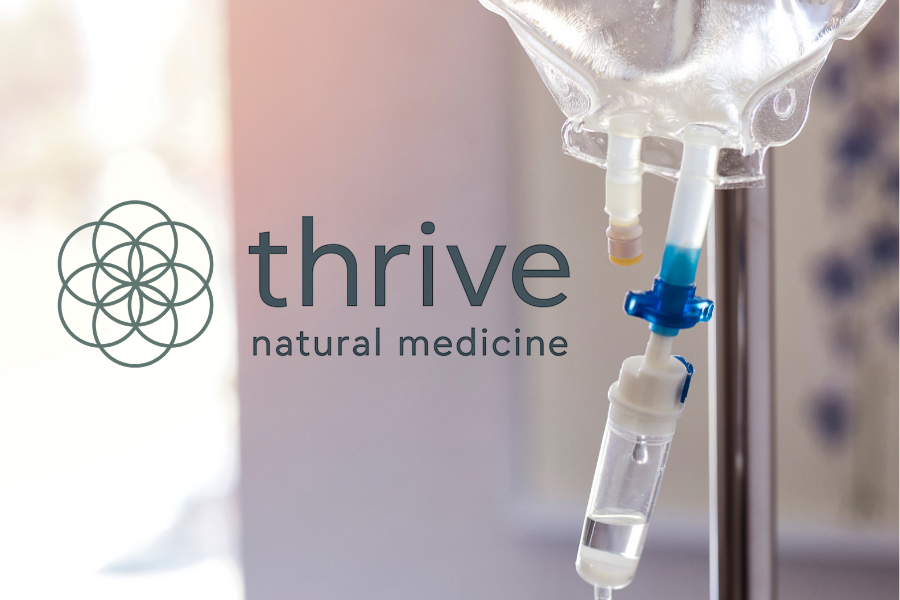 A medical IV drip connected to a fluid bag with 'thrive natural medicine' logo and text