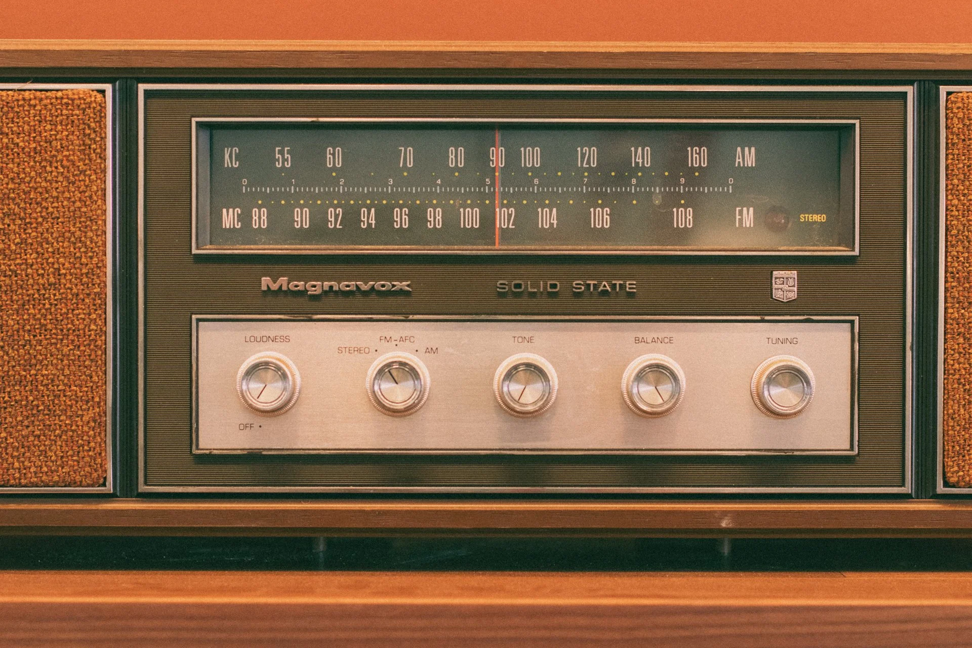 Close-up of a vintage Magnavox solid state stereo radio with tuning and volume controls.
