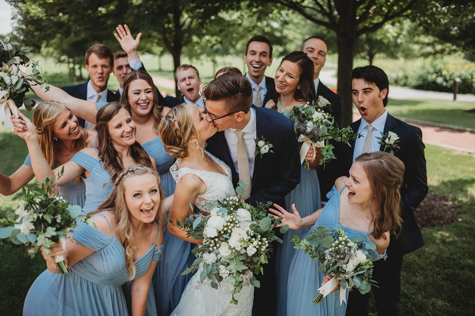 Photo of bride and groom surrounded by bridal party