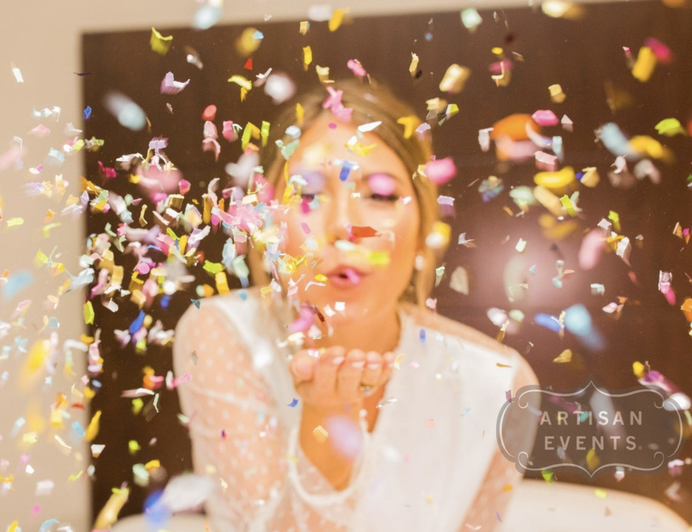 Photo of woman blowing confetti