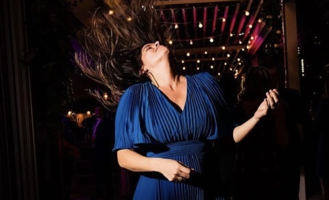photo of woman in a blue dress dancing