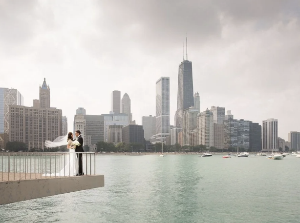 a couple posing in front of Chicago skyline