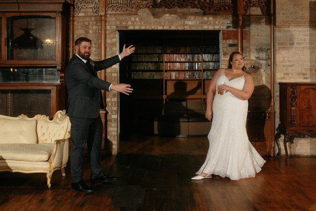 a groom shows off his bride at the wedding