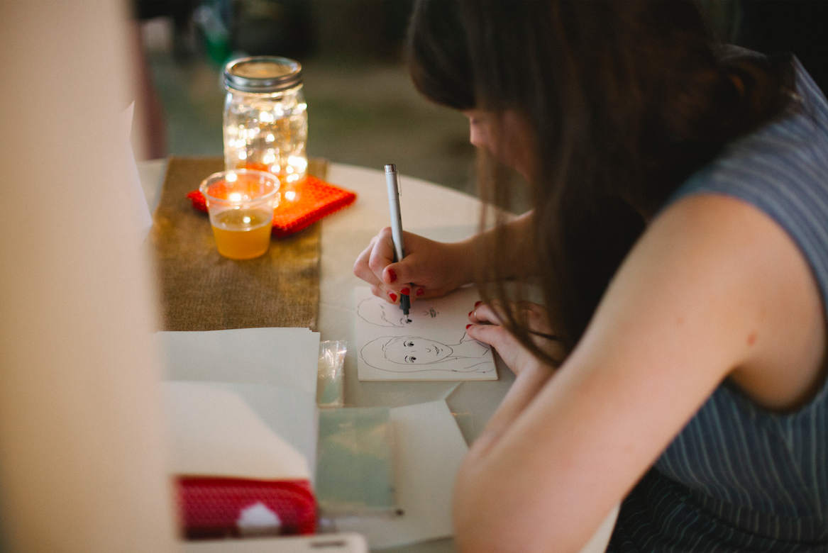 a woman drawing in real time at an event