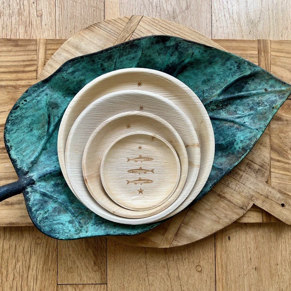 photo of bowls on a large decorative leaf