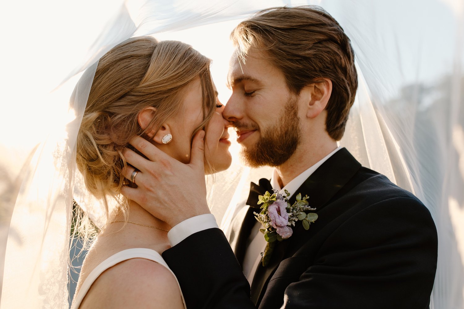close up of bride and groom sharing first kiss