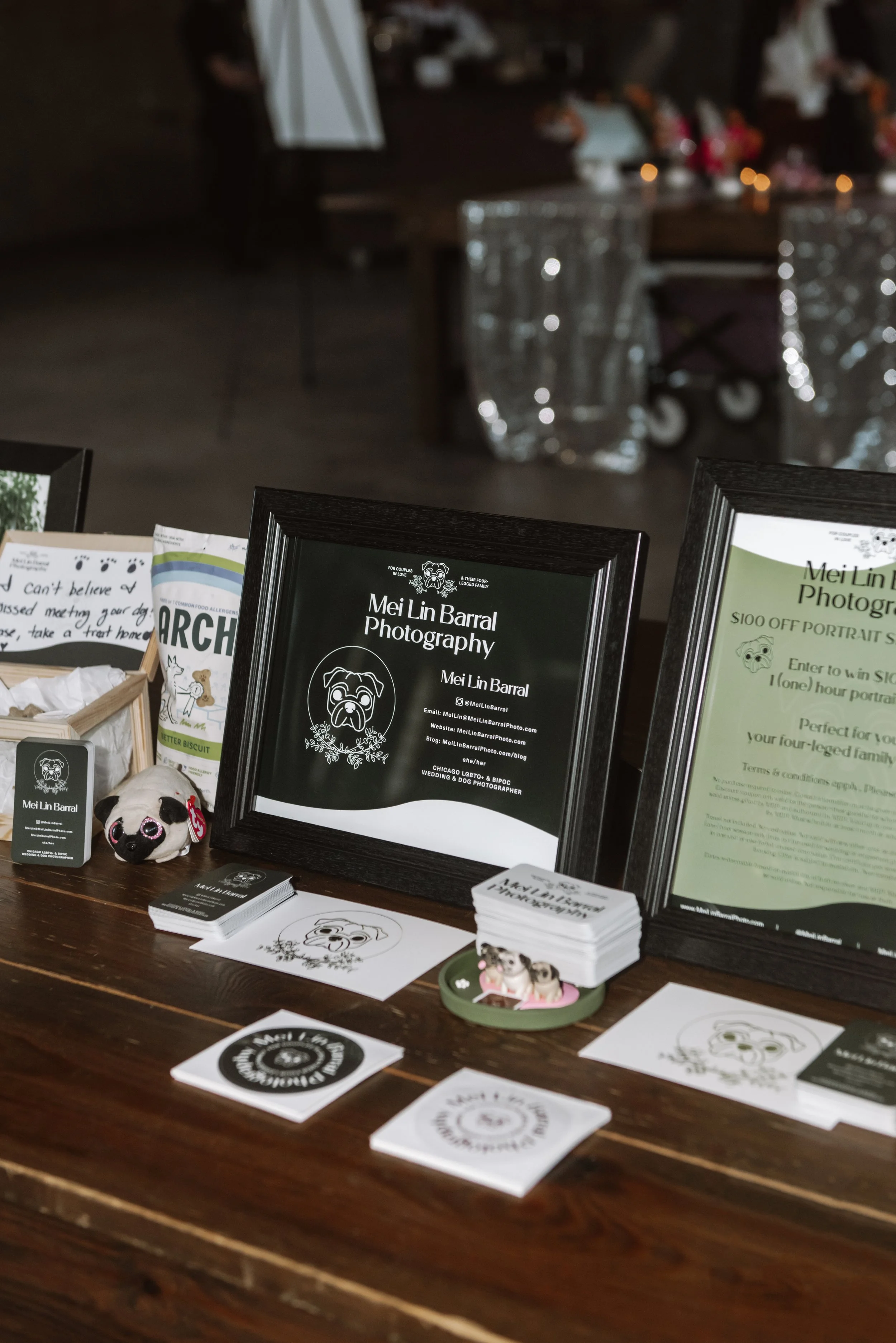 A close up shot of Mei Lin Barral's vendor table, a Chicago area photographer with specialty in pet photographer and queer celebrations.