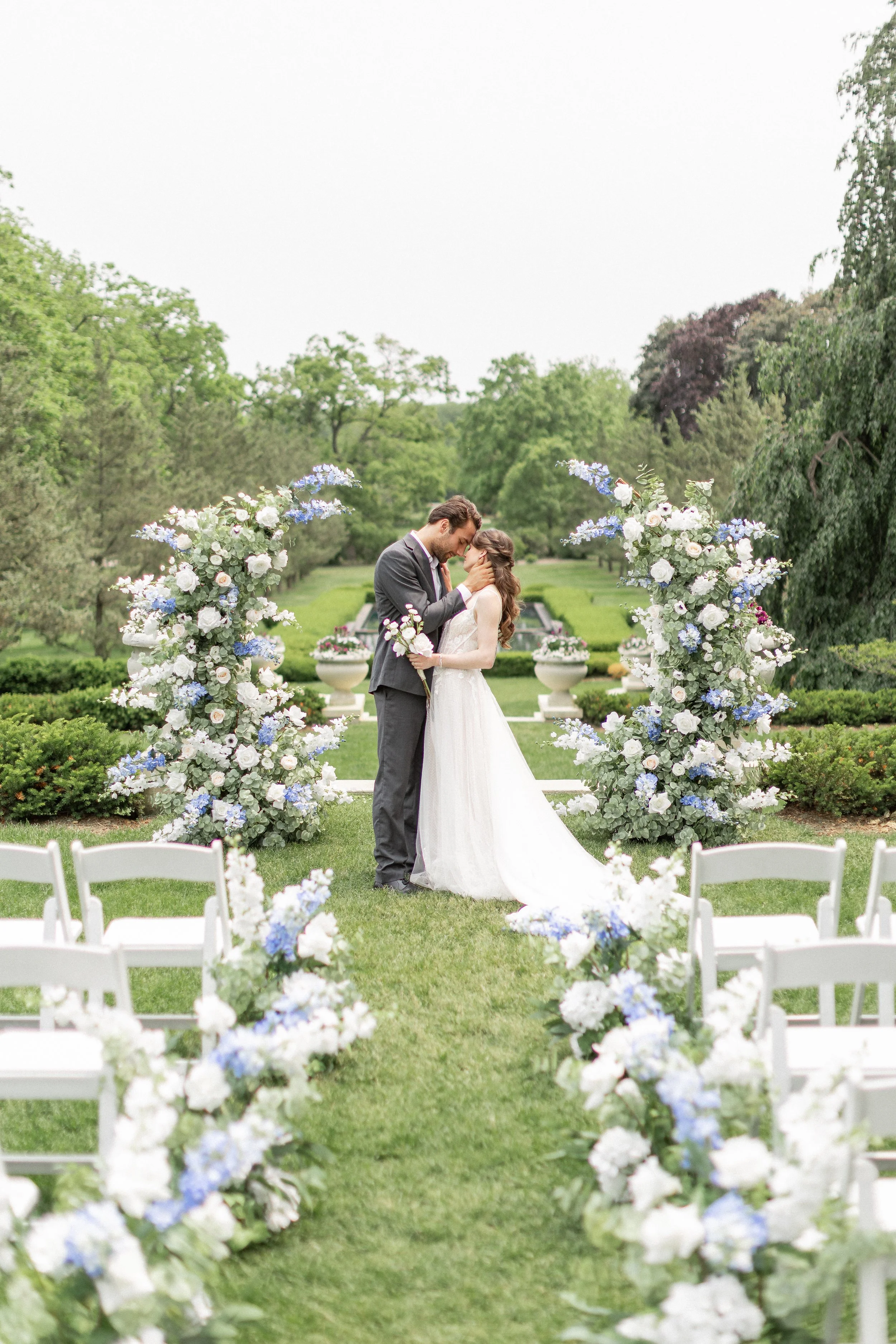 bride and groom pose with their ceremony alter