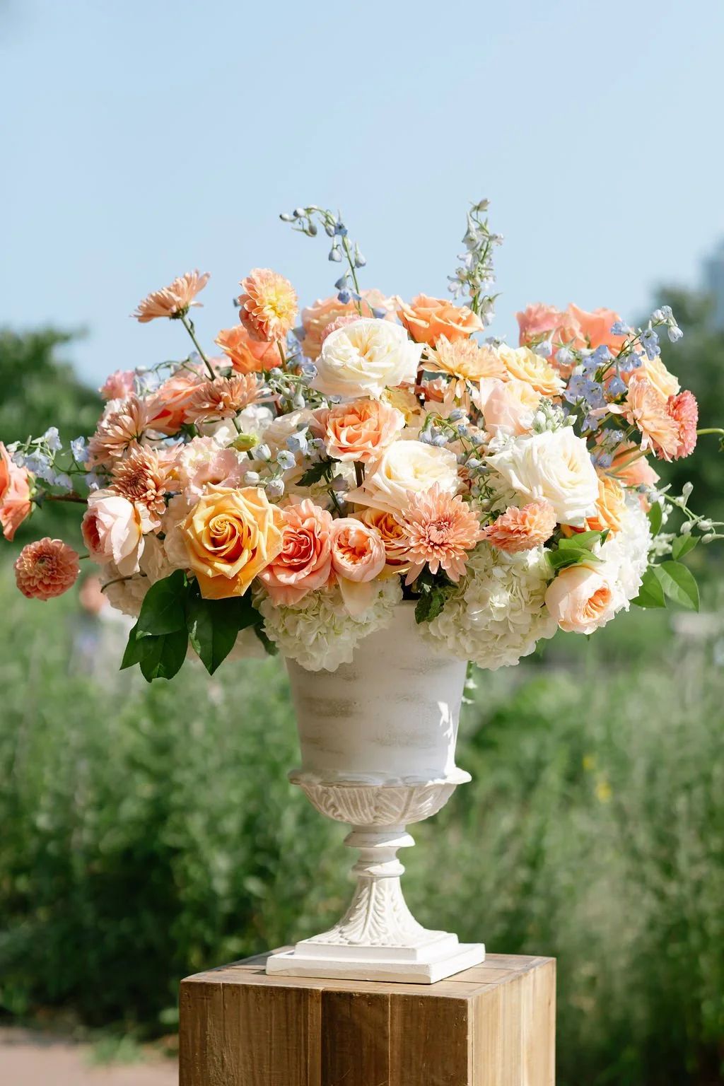floral arrangement with peach toned assorted flowers