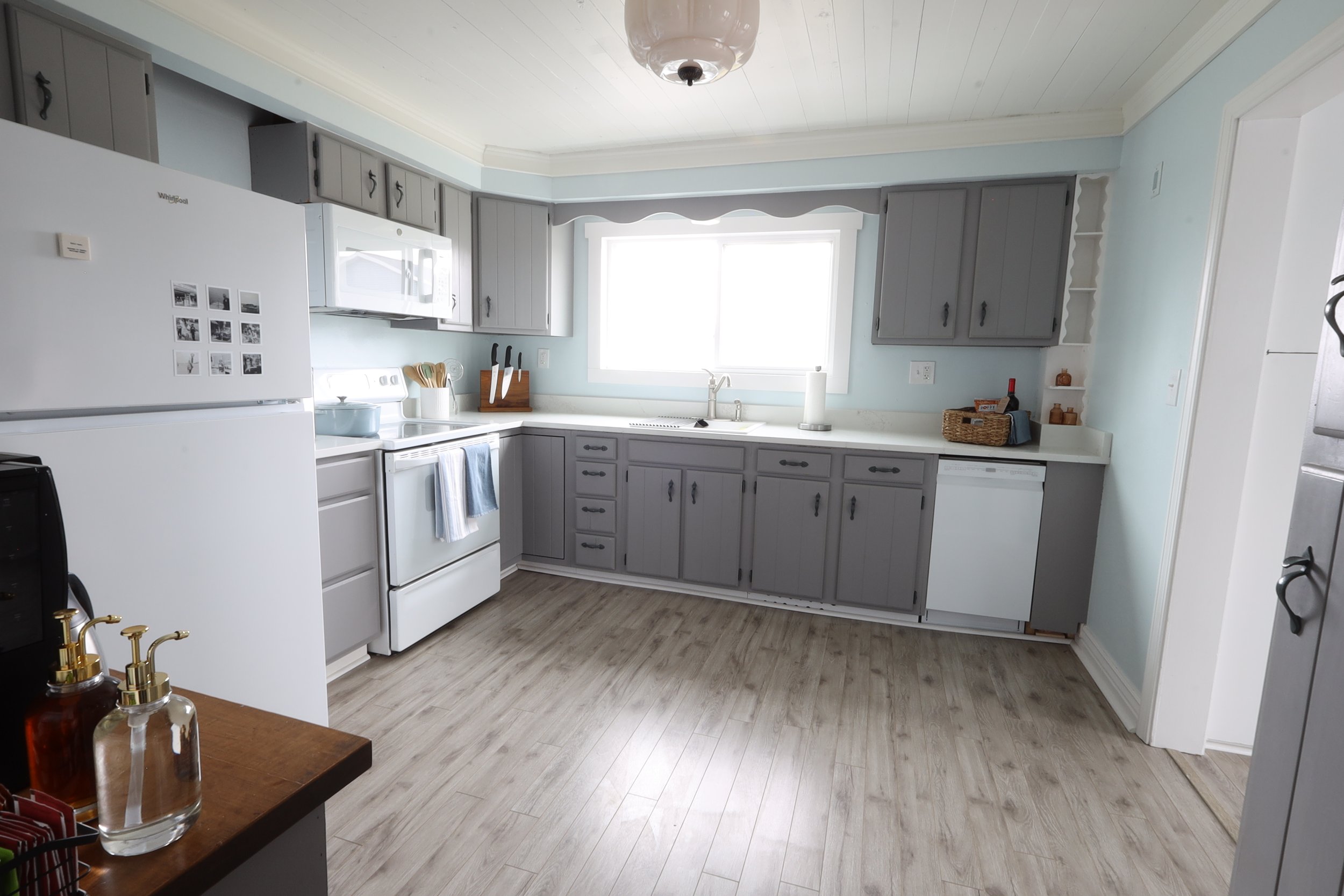 Meal-ready kitchen with small dishwasher, ice maker, electric stove, and coffee station with lots of options