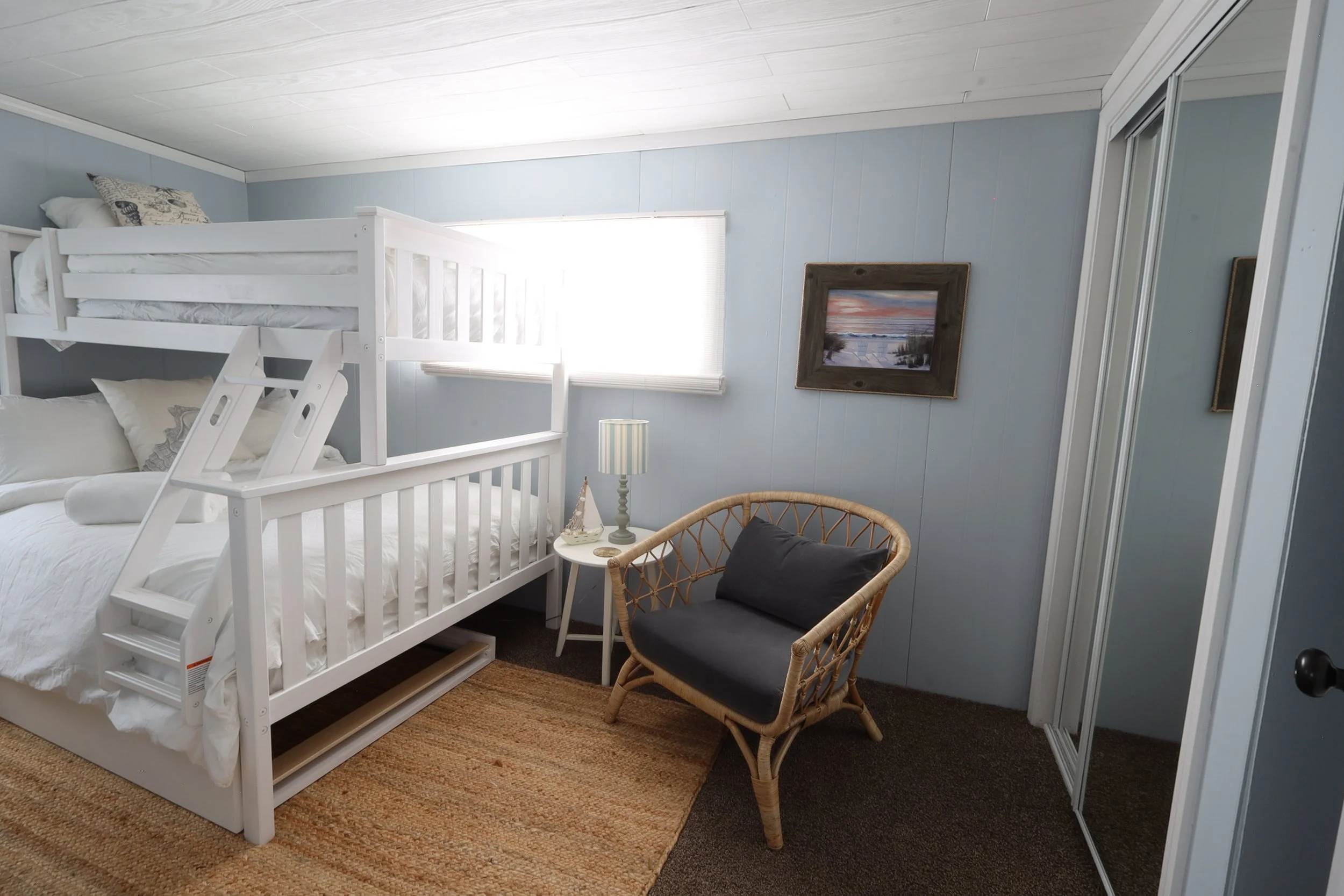 Kids room with full bed, twin bunk, 2 TVs, and large closet