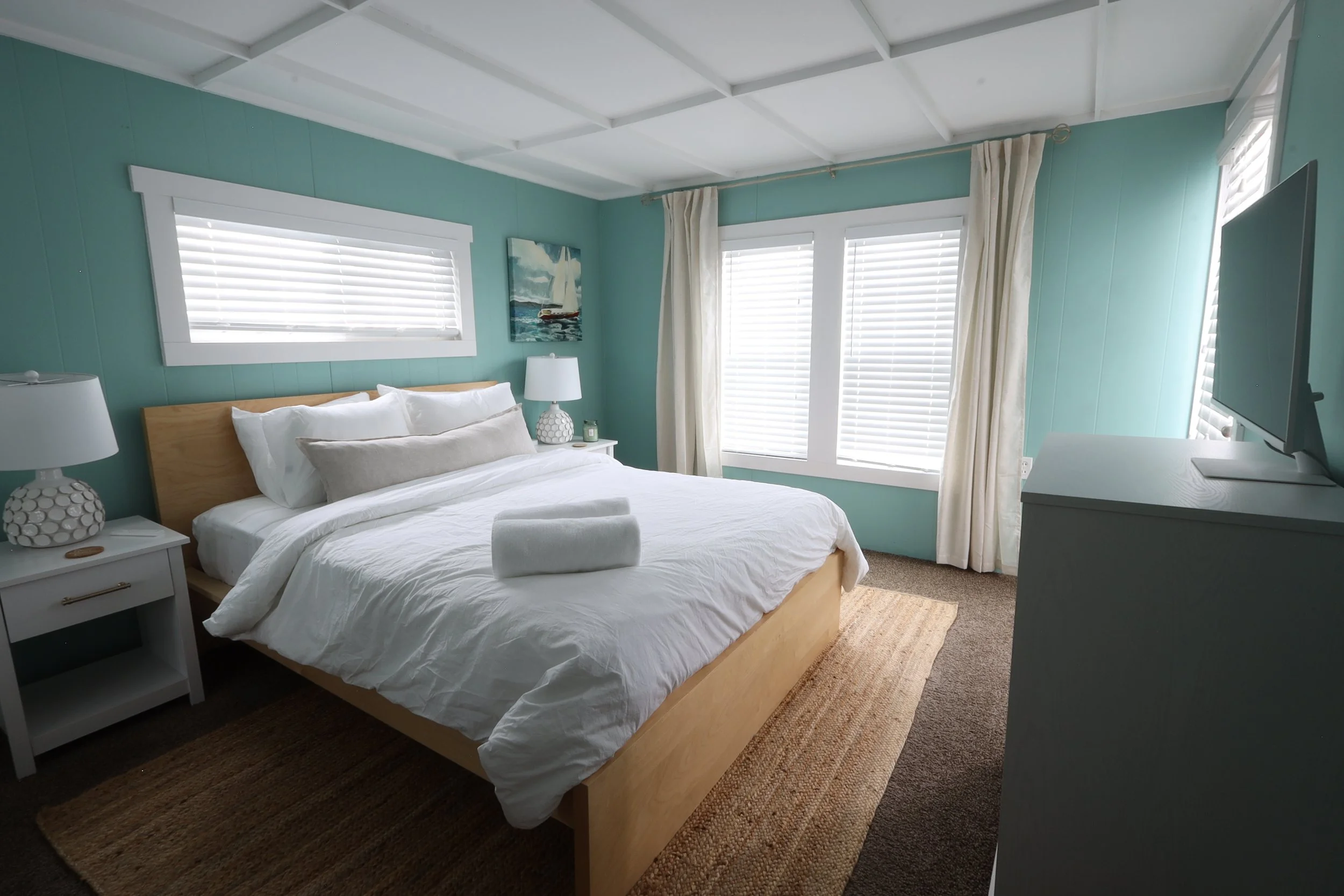 Primary bedroom with deck access, desk, TV, and closet