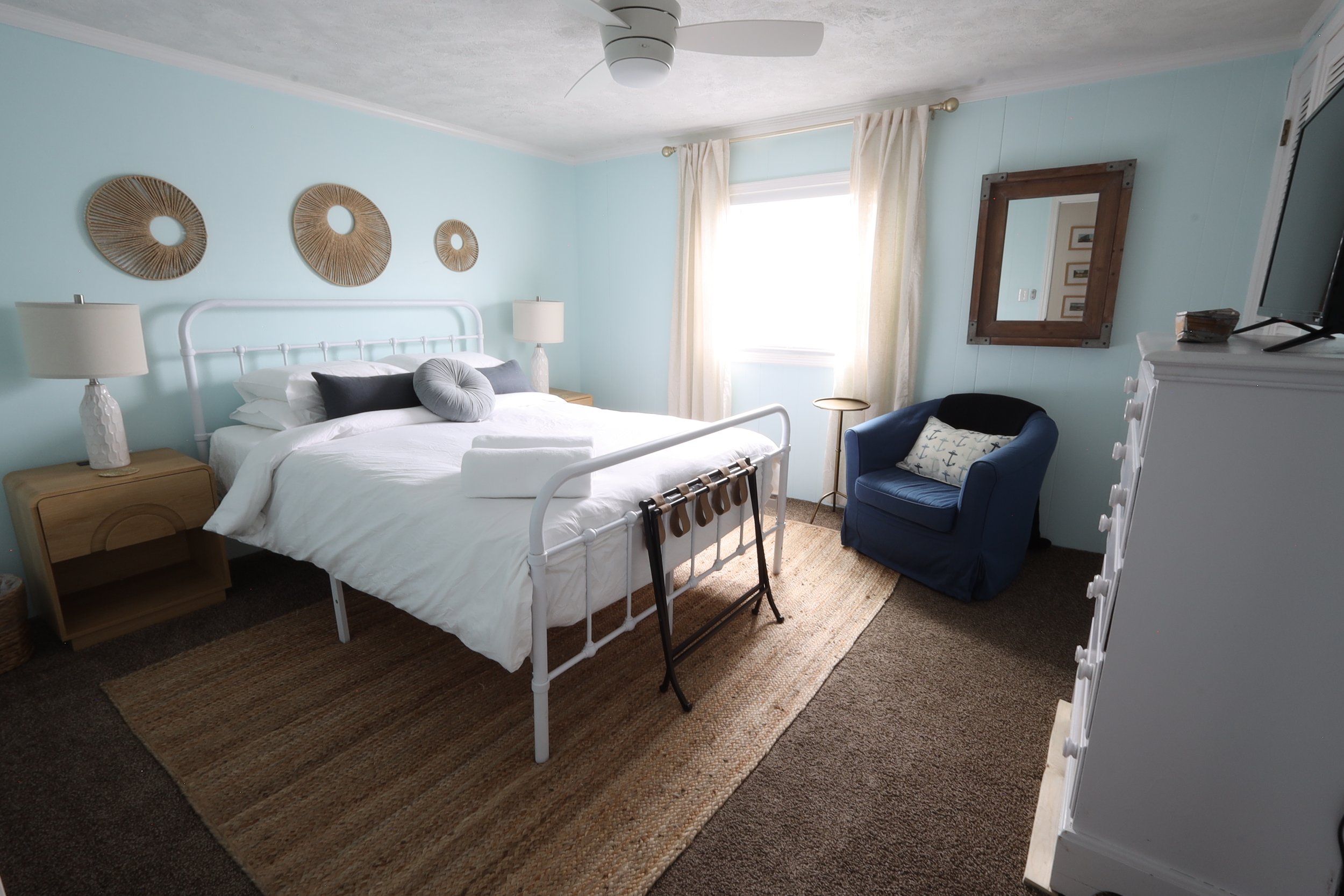 Guest bedroom with large closet and TV