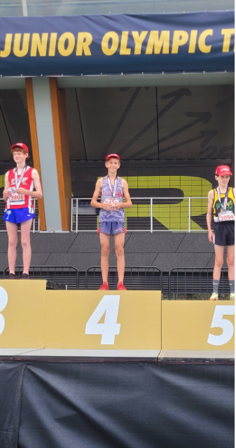 Athlete receiving medal for placing 4th at Junior Olympics for track 