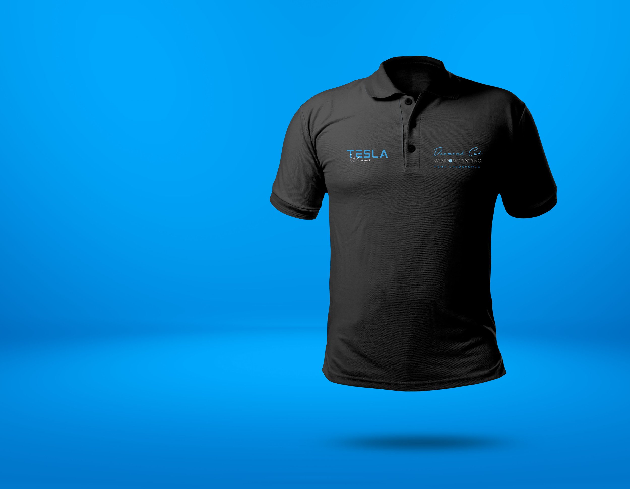 Black polo shirt with blue and white text and logos, floating against a blue background.