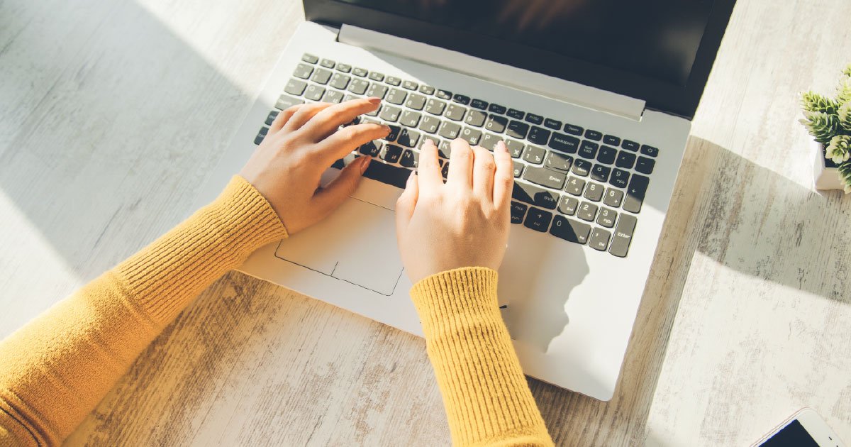 woman typing on laptop