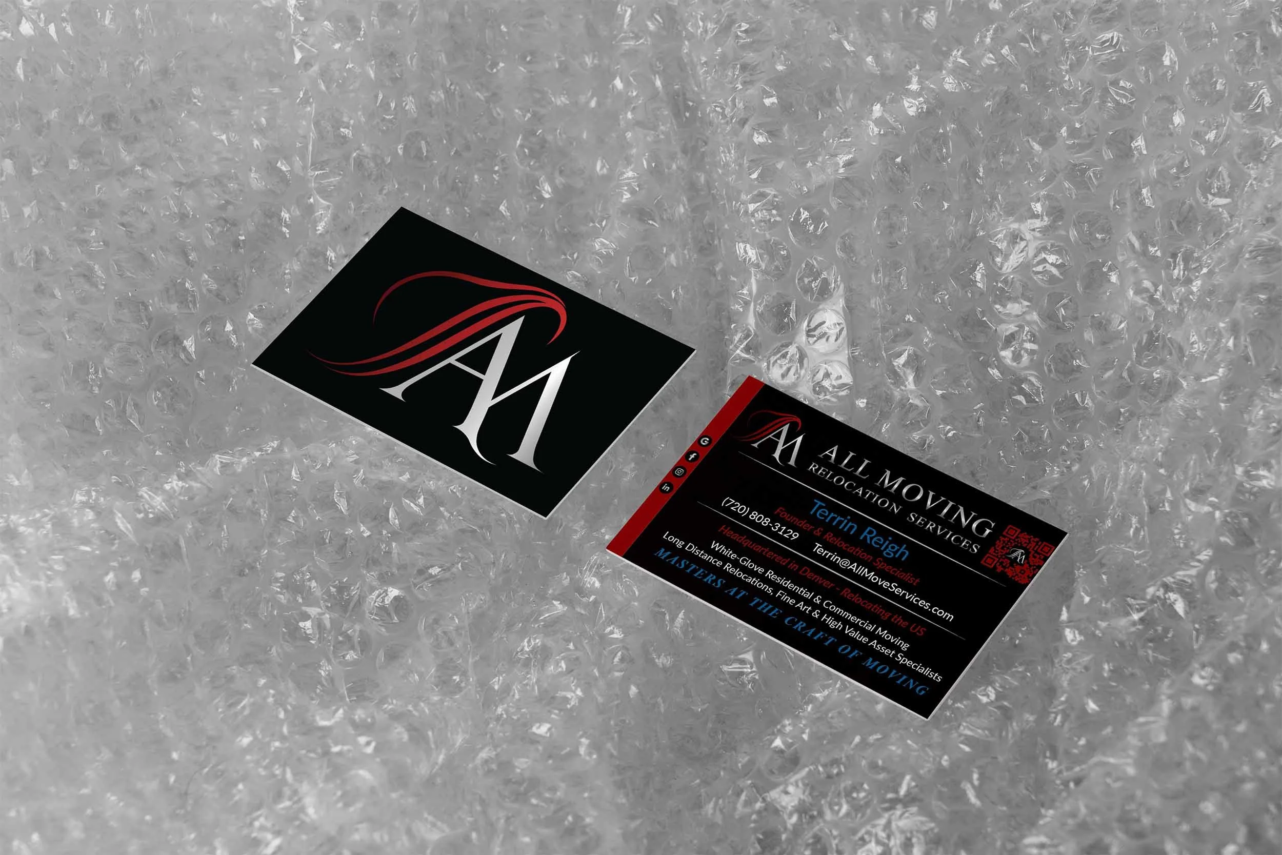 Business card for All Moving Relocation Services, placed on bubble wrap. The card features the company's logo with an 'A' and 'M' in a stylized font, a QR code, and contact details for Terrin Reigh, a headquarter relocation specialist based in Denver, Colorado.