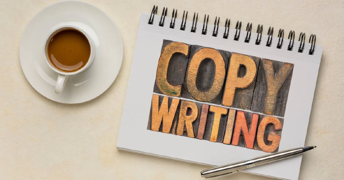 Coffee Cup on Desk with decorative sign reading copywriting
