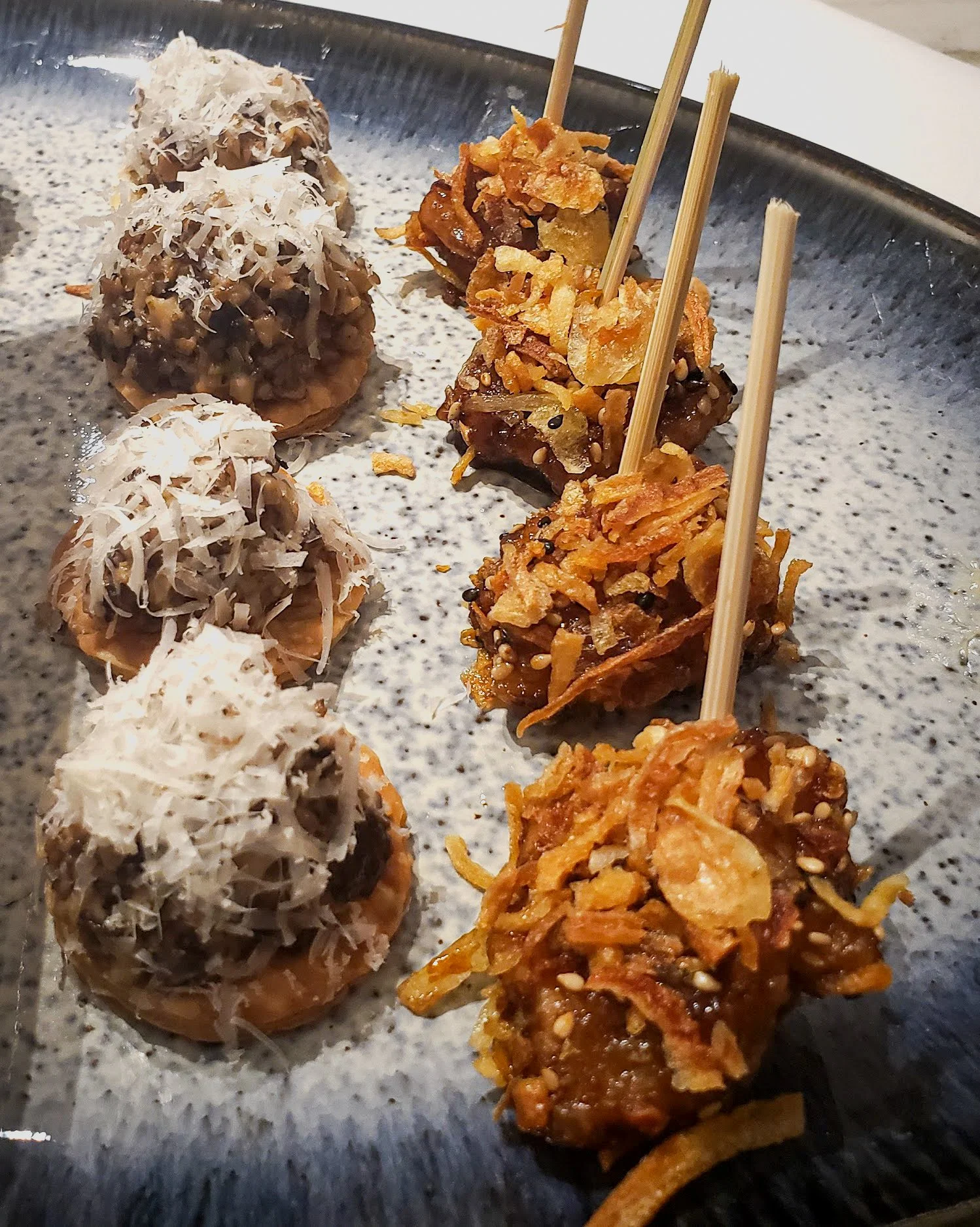 Koreanna Kitchen appetizer platter with mushroom bites topped with cheese and crispy fried chicken bites on skewers