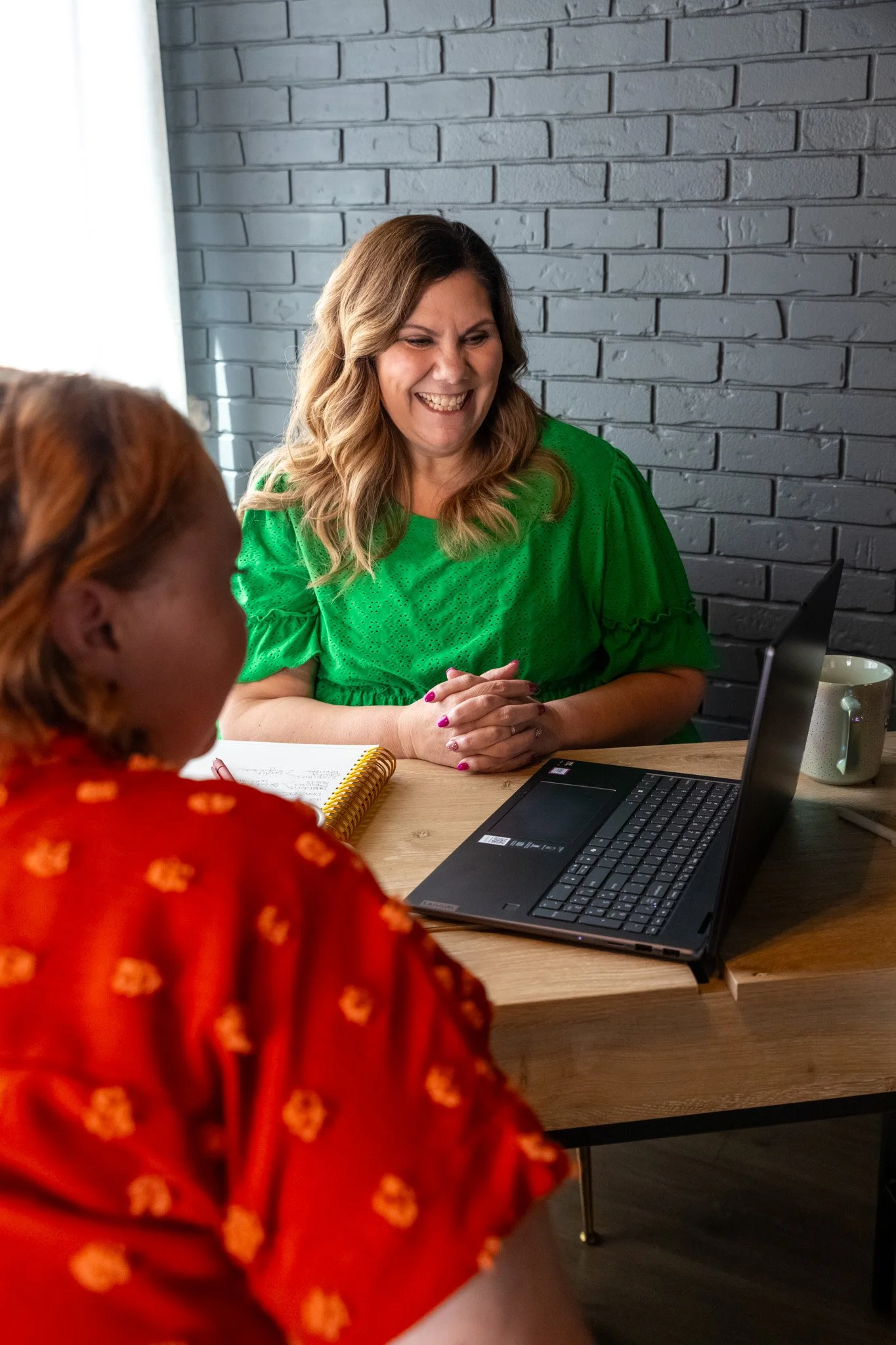 Small business bookkeeping consultation in Houston office with client and bookkeeper.