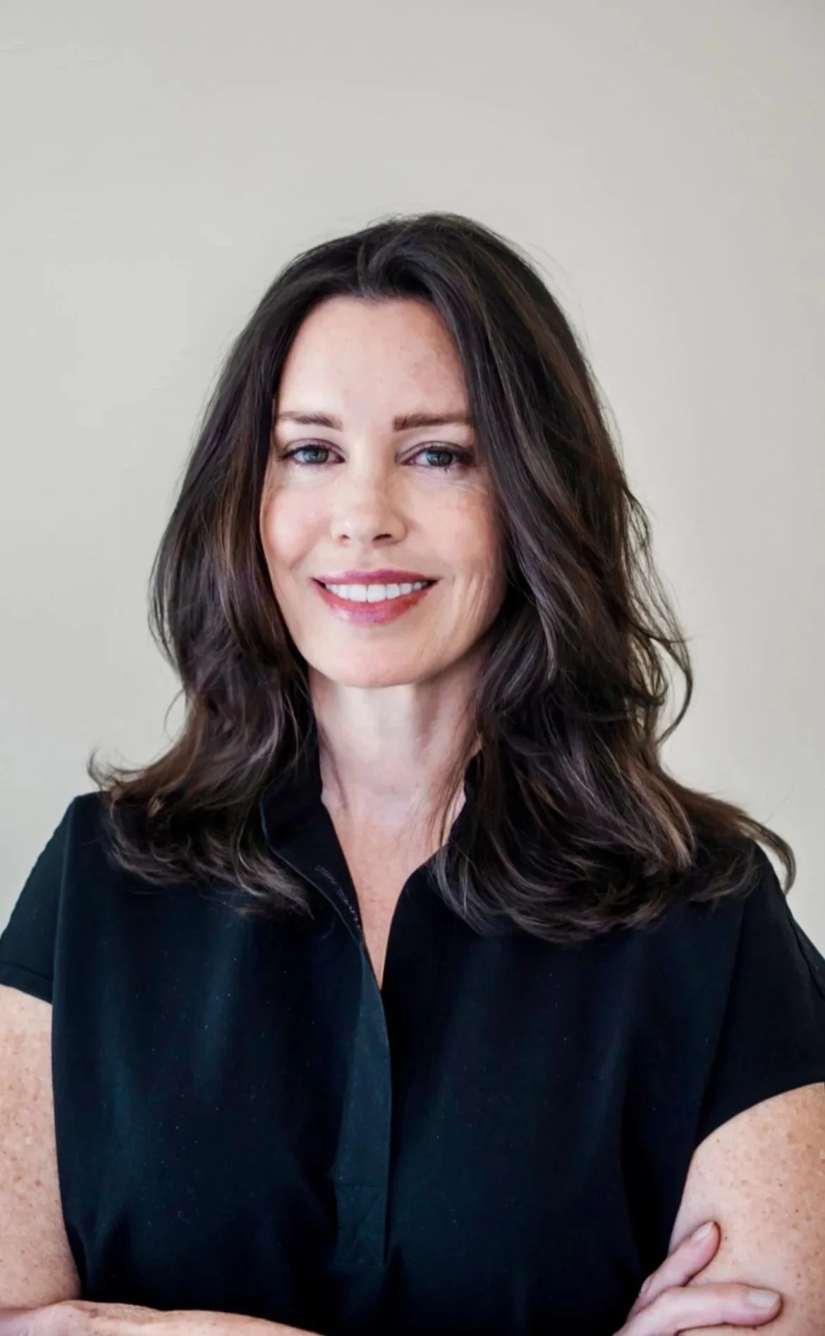 Image of a brunette woman named Jennifer Braswell, an esthetician working at Woo SKincare and cosmetics in Atlanta Georgia