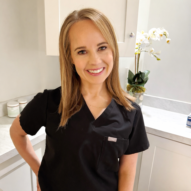 Image of a blond woman in scrubs, her name is Mallory Hamilton and she is an aesthetician in Nashville, TN