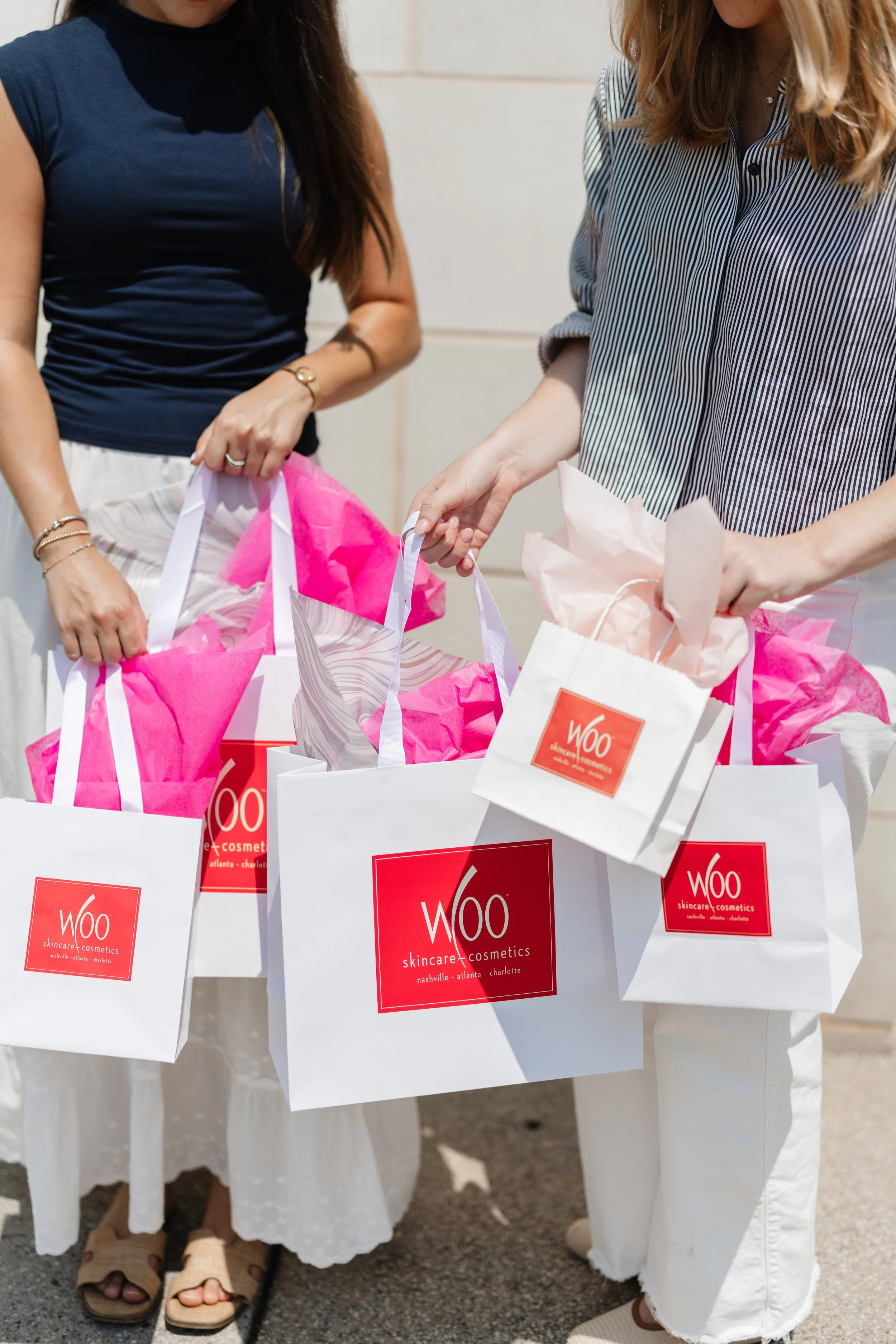 Image of Woo Skincare and Cosmetics shopping bags that links to purchasing gift cards