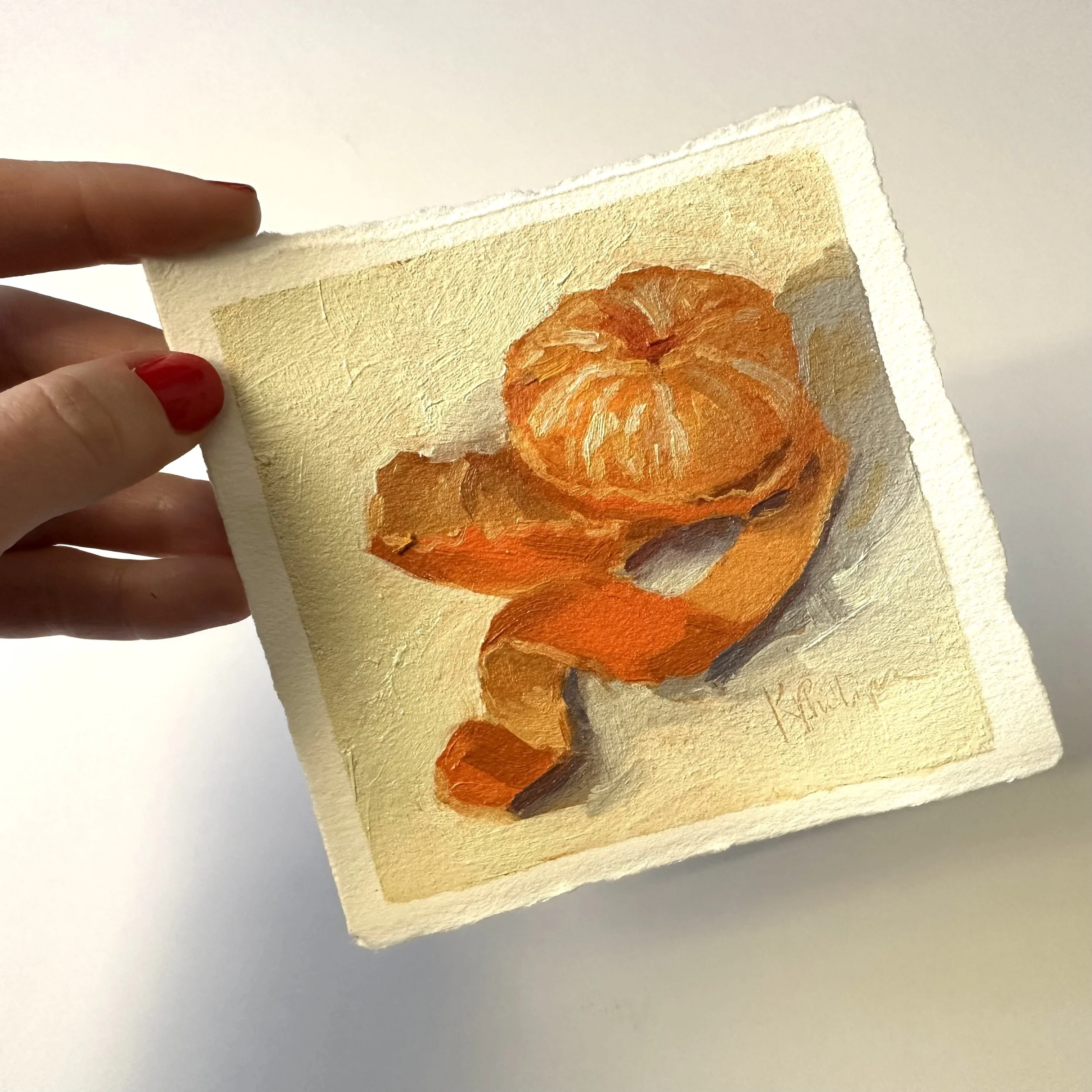 Watercolor painting of a curled orange seashell on a beige background, held by a person with red nail polish.