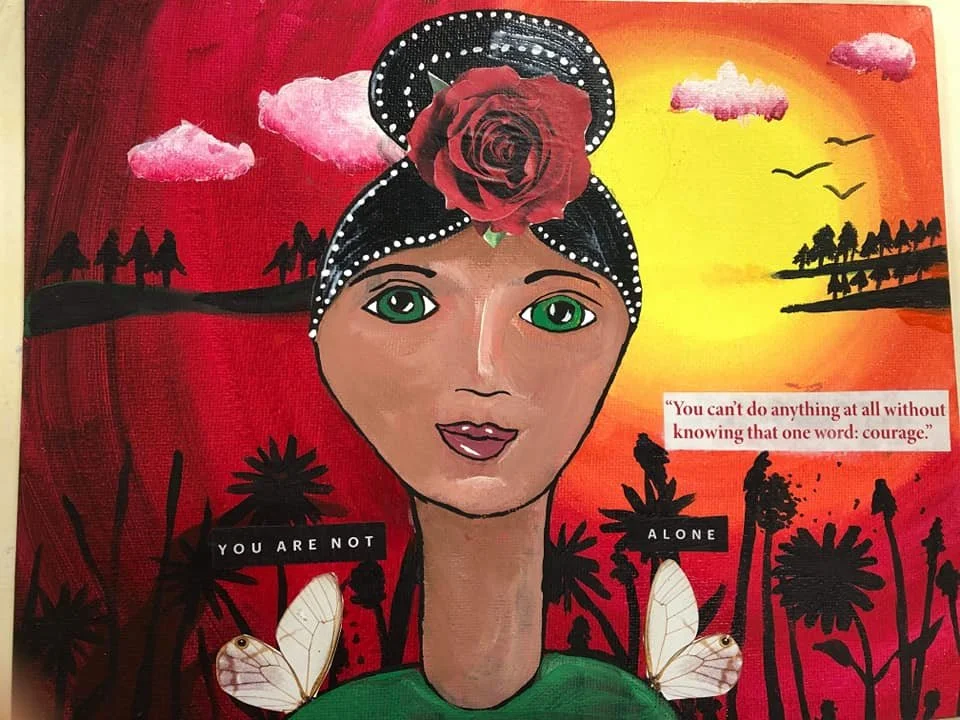 A colorful painting of a woman with green eyes, dark hair adorned with a large red rose and a black and white polka-dot headband. The background shows a sunset with clouds, birds, and silhouettes of trees and people holding hands. There are two butte