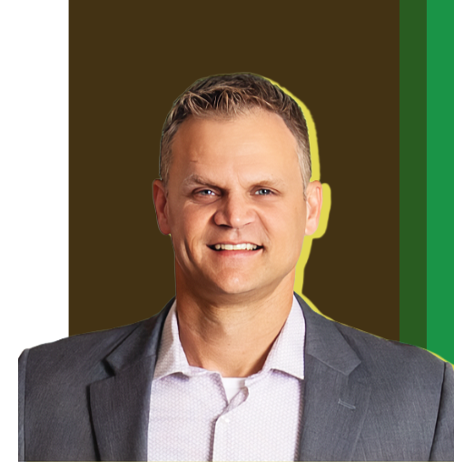 A man in a gray suit smiling against a brown and green background.