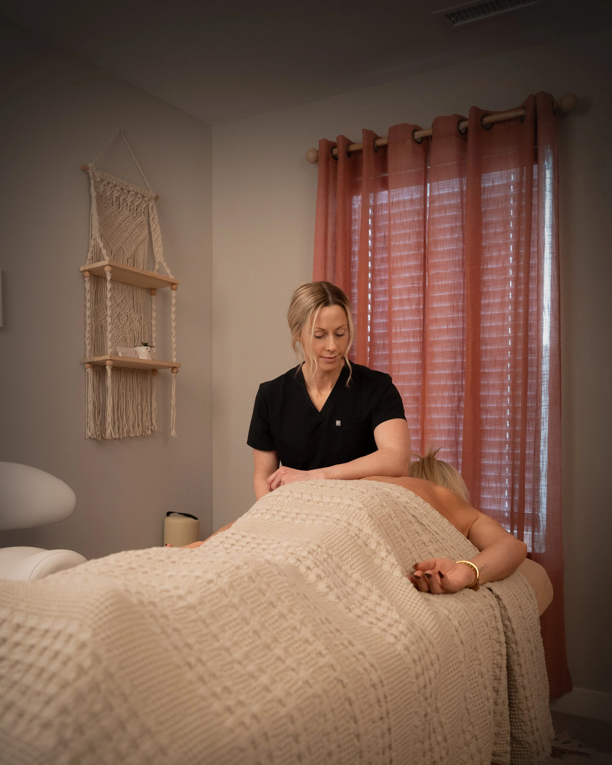 This is a picture of the primary massage therapist giving a massage to a client who is draped