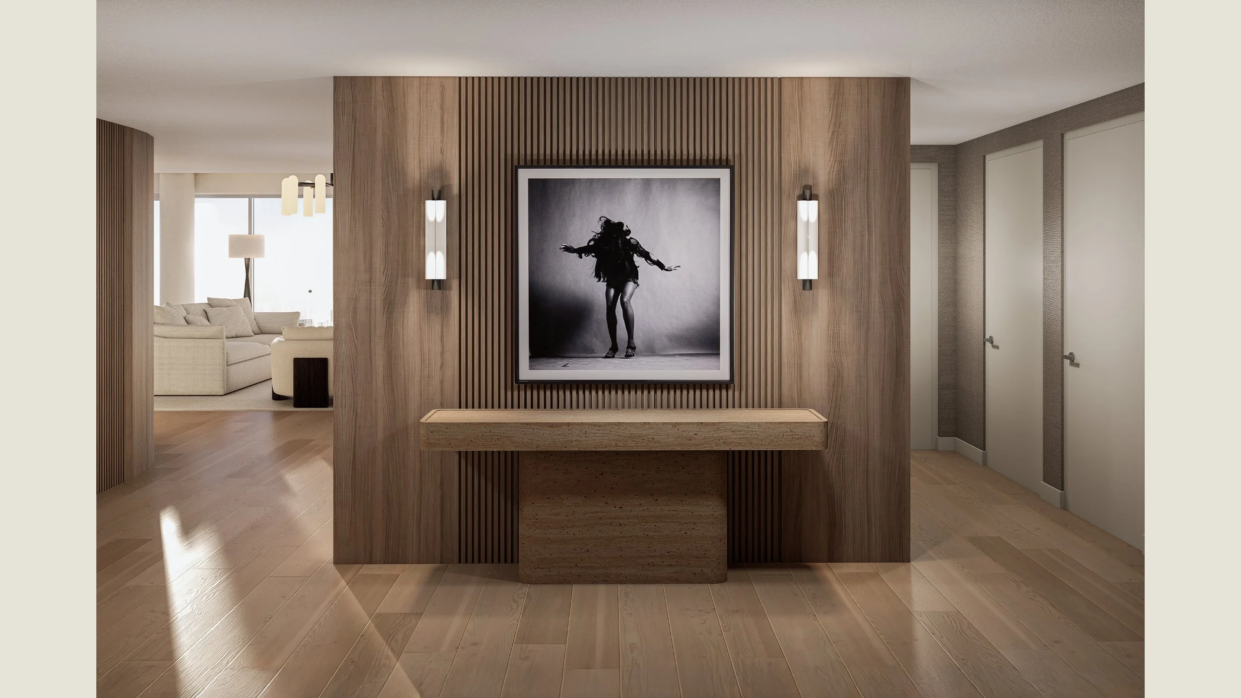 A modern living room with a beige sofa, a floor lamp, and a large window in the background. The foreground features a wooden divider with gallery wall art of a dancing woman, flanked by two wall sconces.
