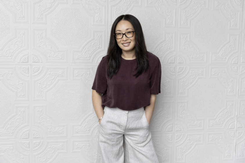 Person standing in front of white wall