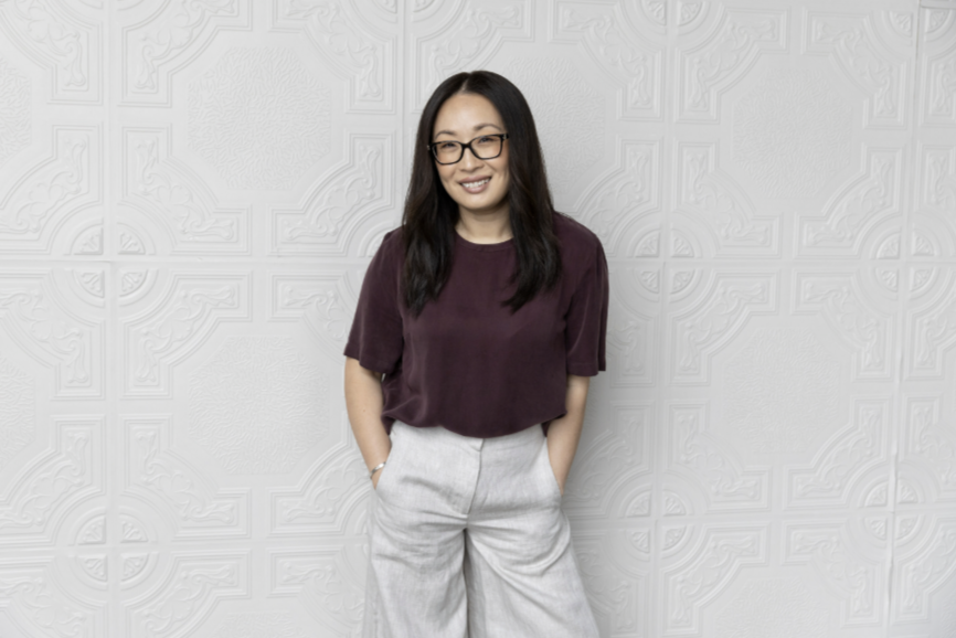 Person standing against a white textured wall