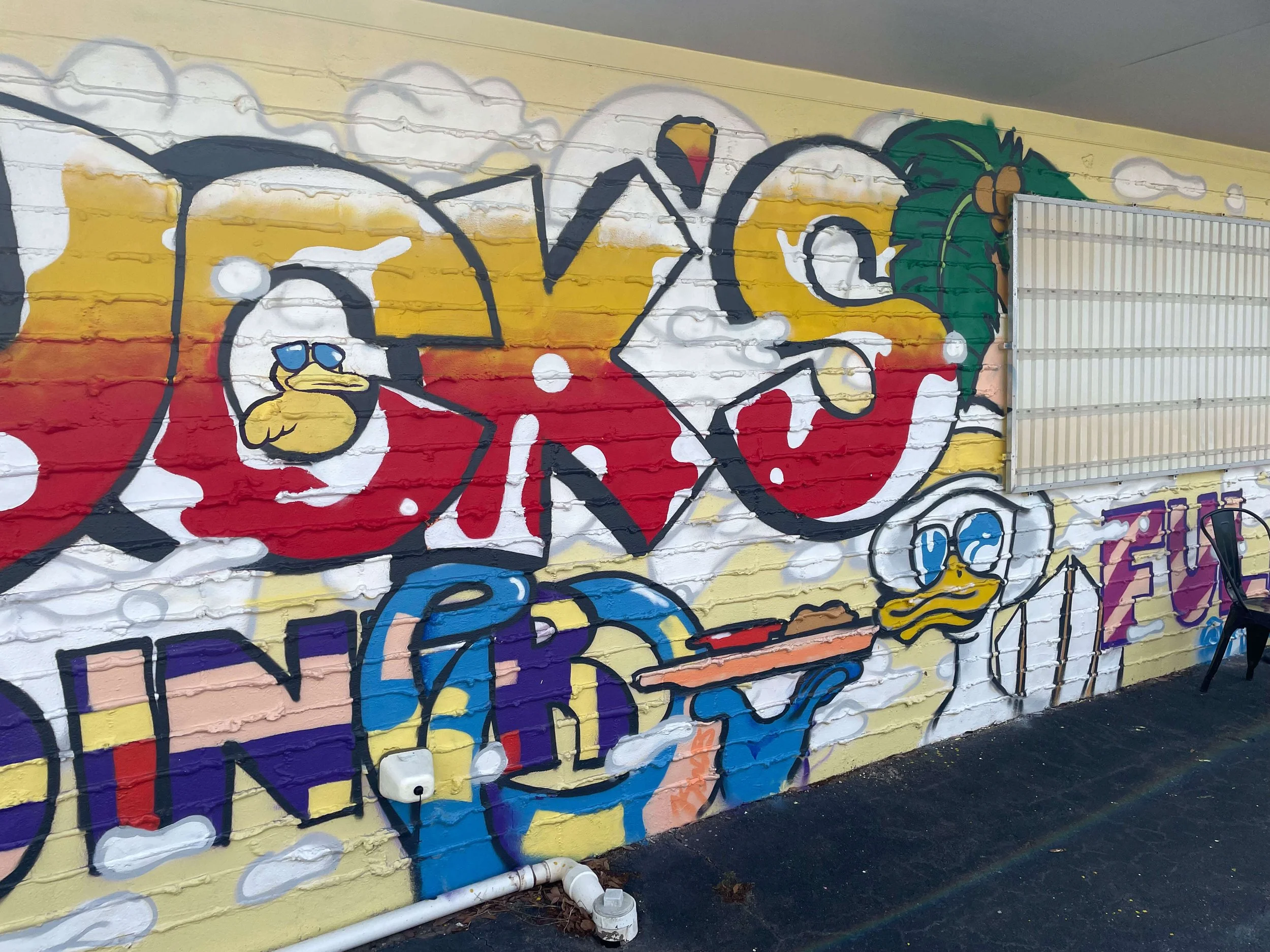 Right side of Duck’s Diner mural showing duck waiter character holding food tray, Gulf Shores AL, 2025.