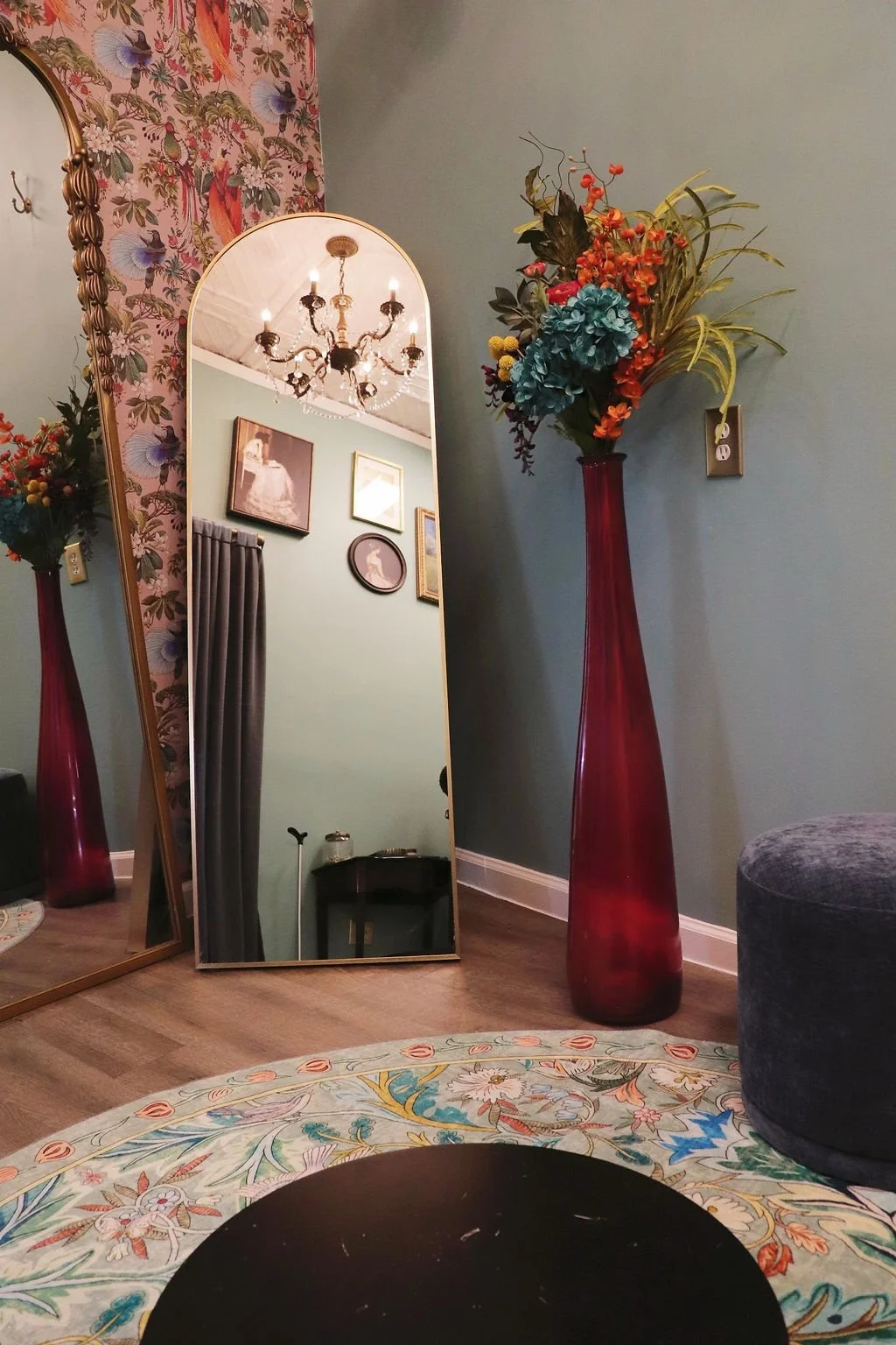 Fitting room corner with tall red vase