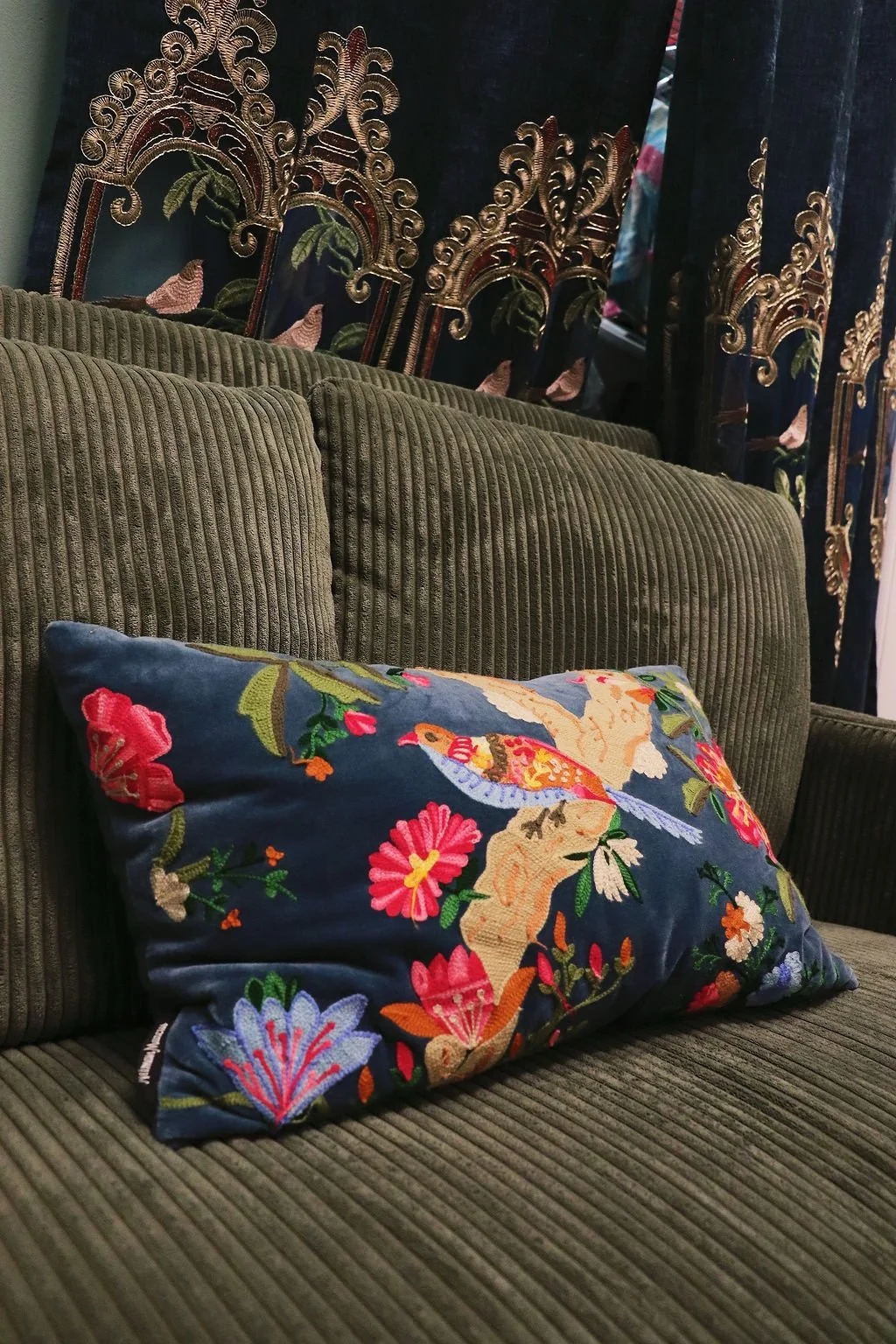 Embroidered bird pillow on the boutique sofa