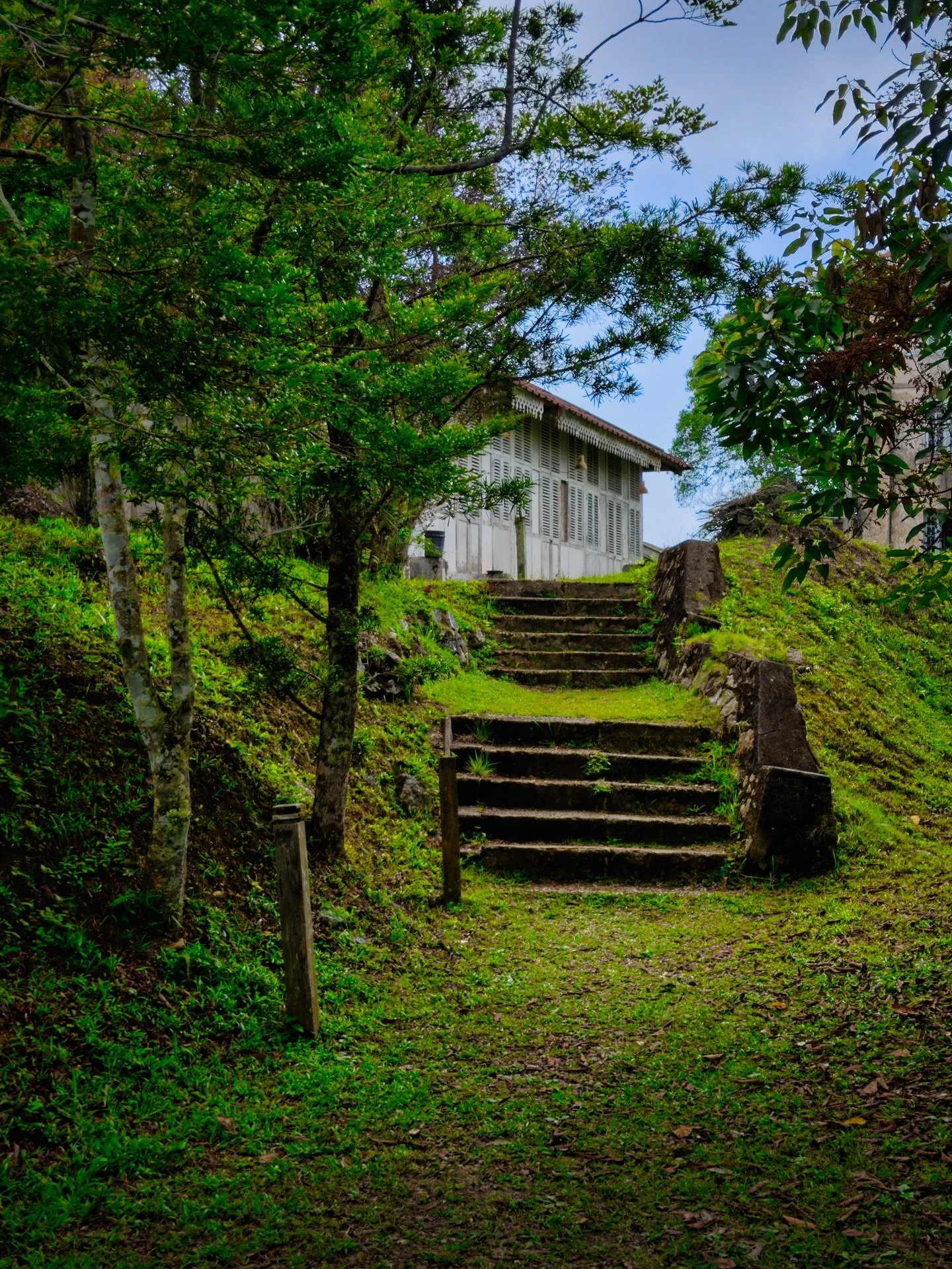 I rounded a bend on one of Penang Hill&rsquo;s trails and there it was&hellip;.a massive, derelict building being slowly eaten by time and nature. Vegetation slowly creeping in, debris scattered inside, and a date carved into the stonework: 1929. I h