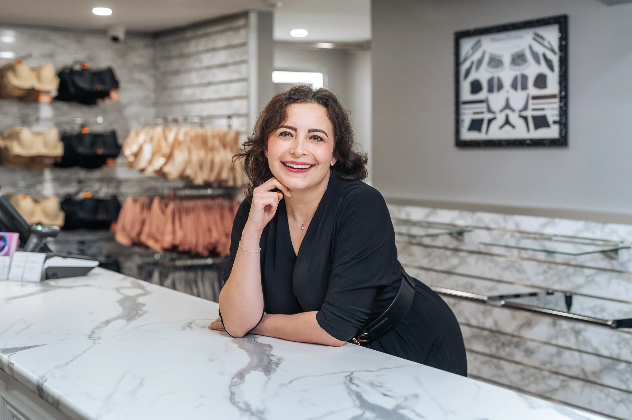 Business profile photo of a woman smiling at a marble counter inside an Adelaide Arcade retail store.