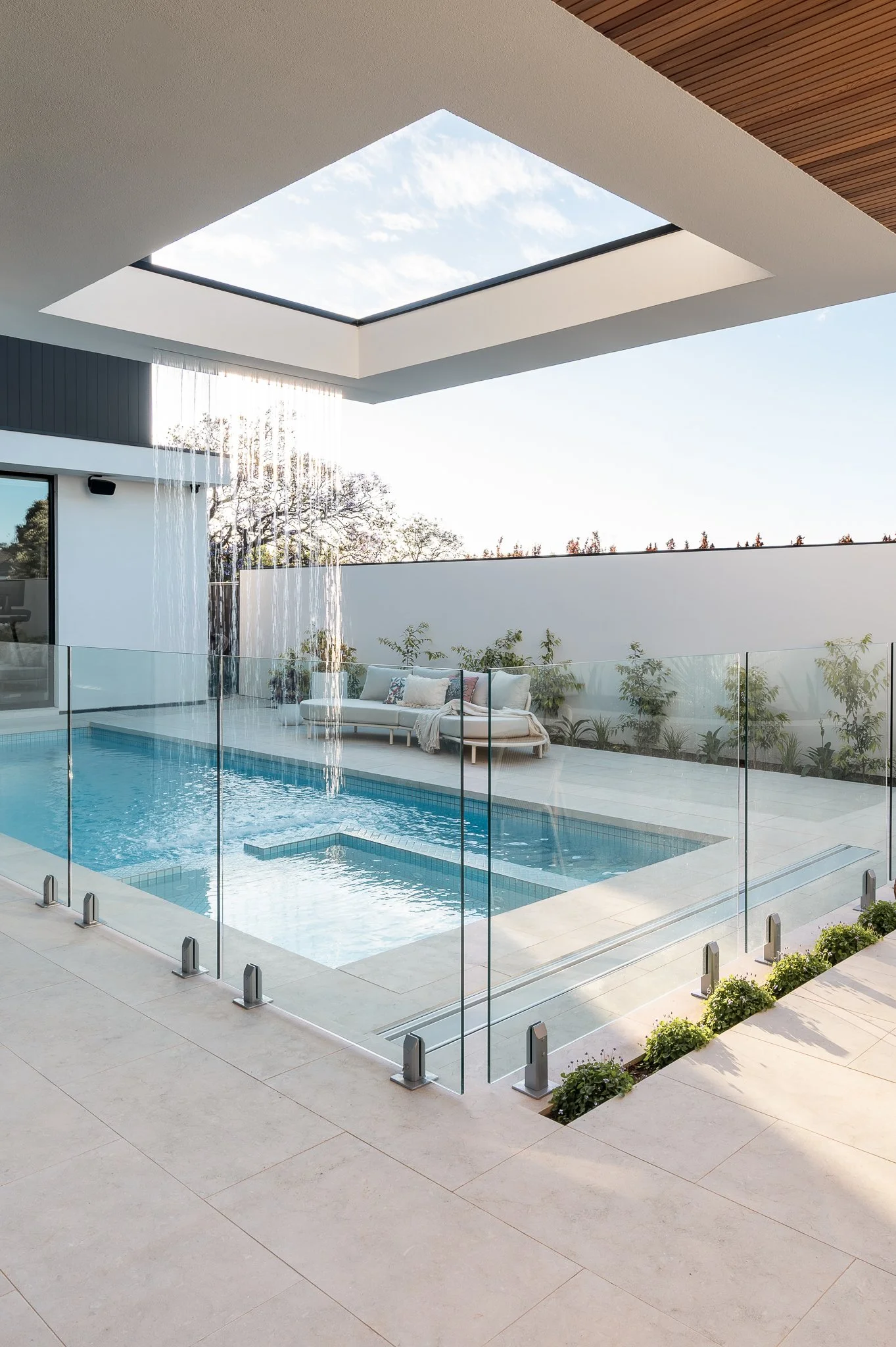 St Georges luxury home exterior showcasing poolside outdoor living space and custom water feature.